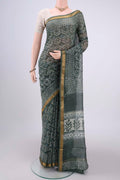 Olive Green Maheshwari Silk Cotton Saree with Batik Print on the body and Zari Border.  displayed on a mannequin