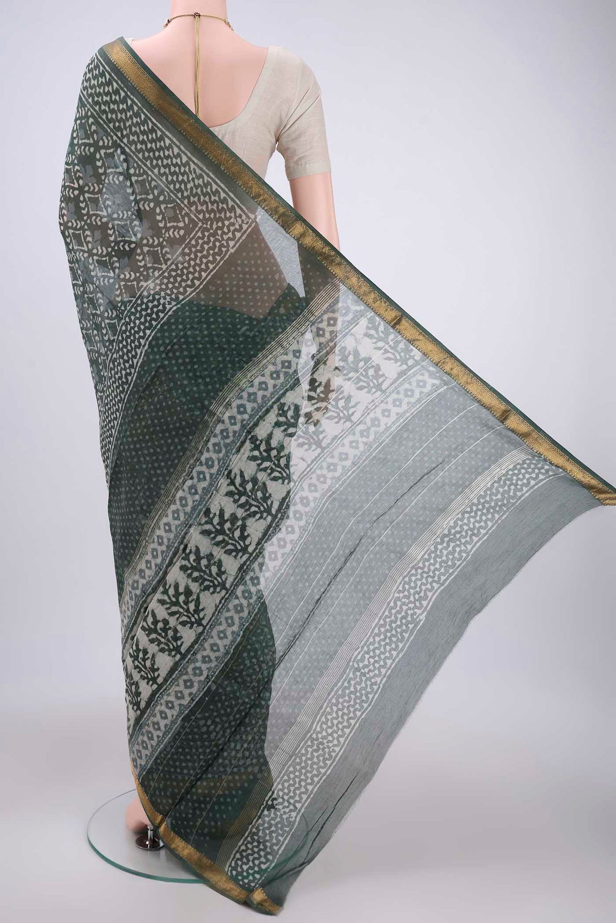 Flat view of Olive Green Maheshwari Silk Cotton Saree with Batik Print on the body and Zari Border. 