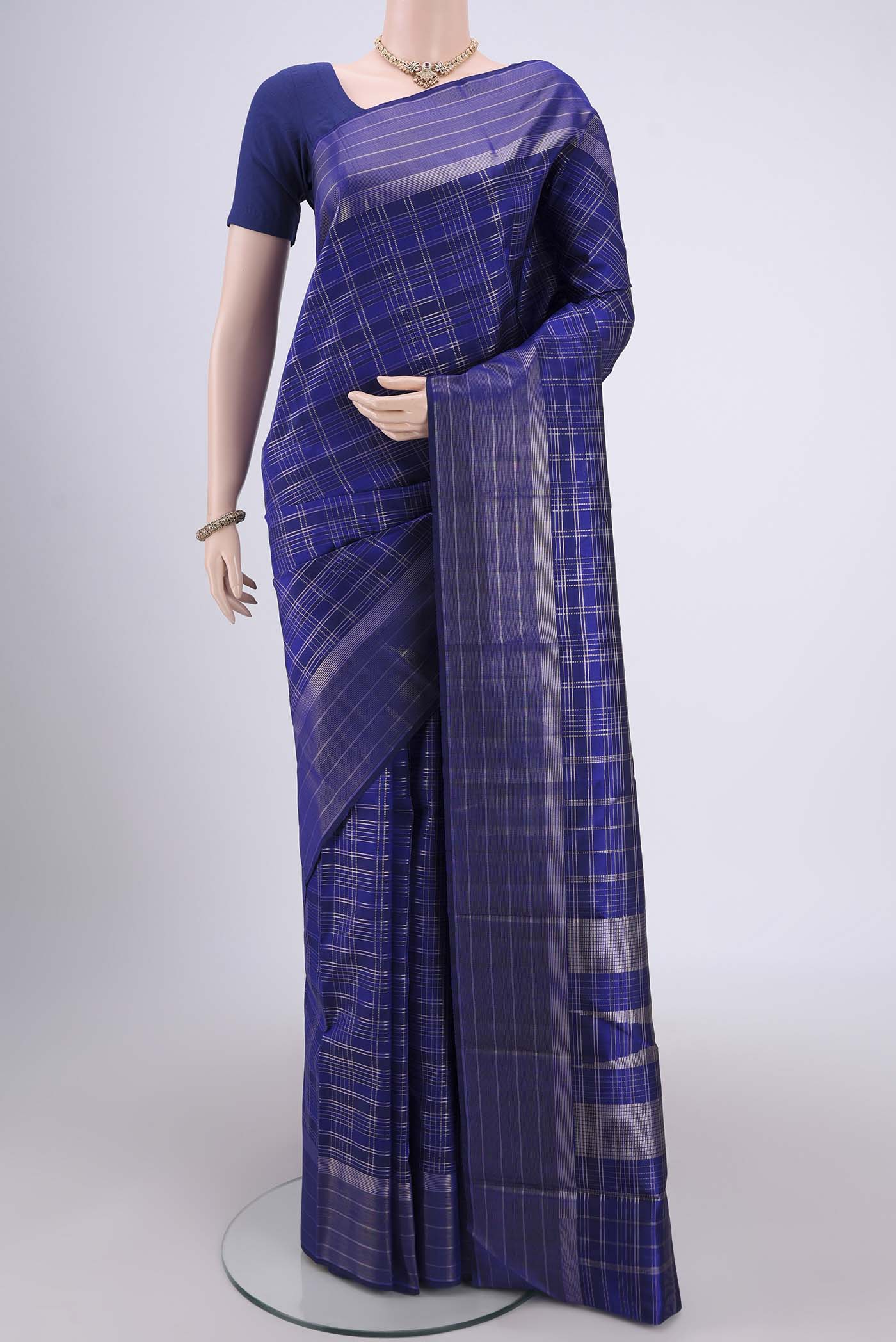Royal Blue Dual Tone Kanjivaram Silk Saree with Checked design on the body and Zari Border.  displayed on a mannequin