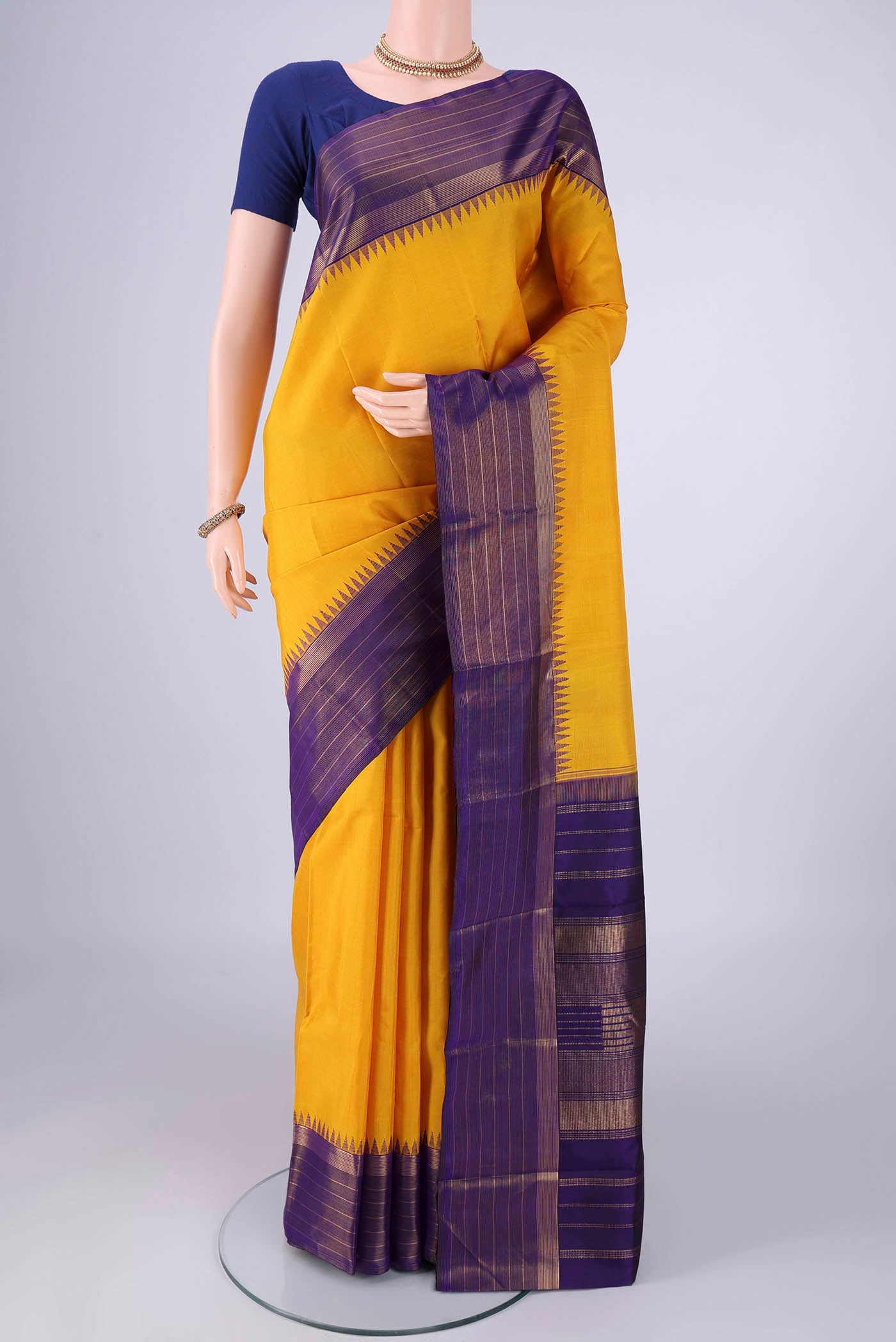 Yellow Kanjivaram Silk Saree with Plain Body and Zari Border.  displayed on a mannequin