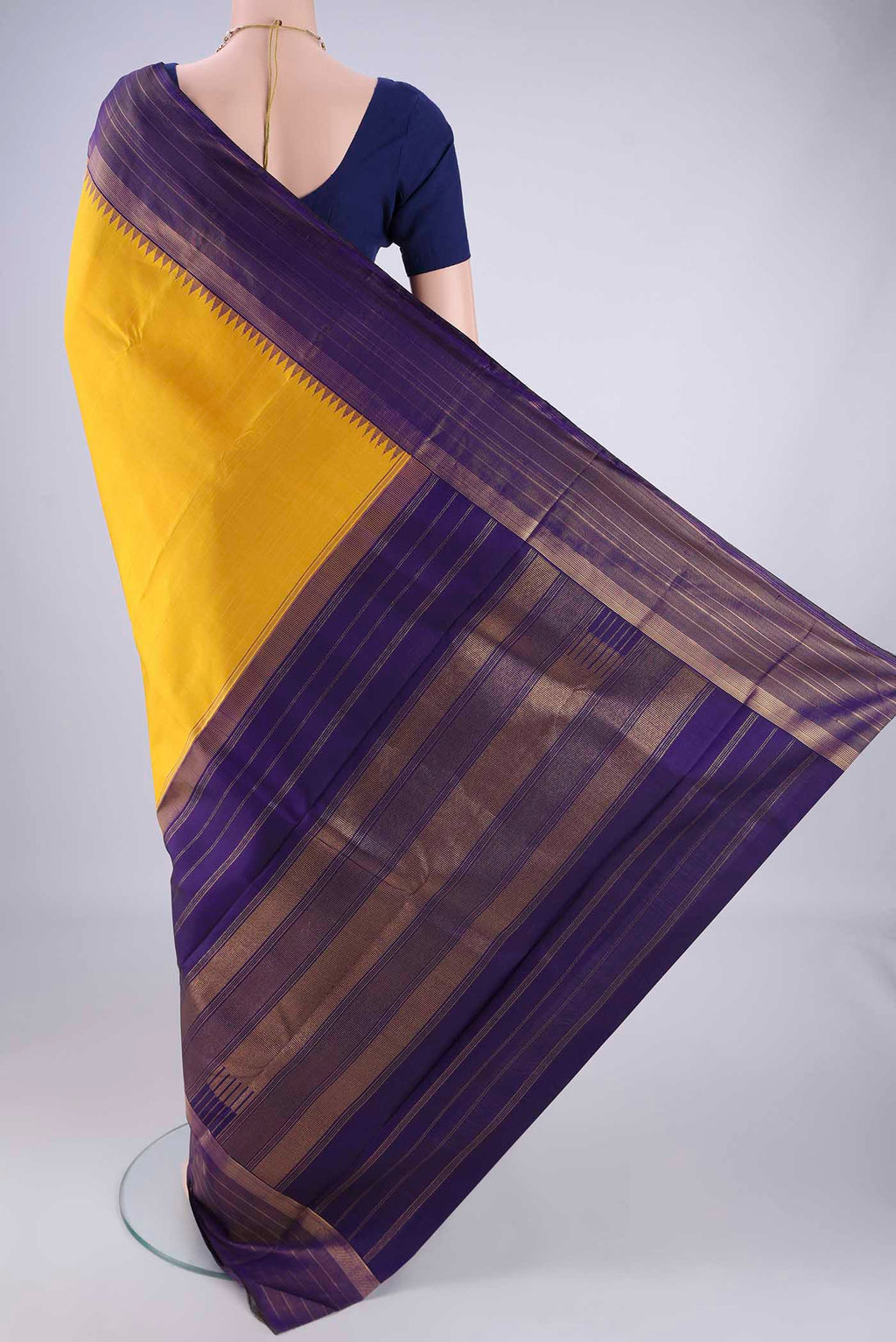 Flat view of Yellow Kanjivaram Silk Saree with Plain Body and Zari Border. 