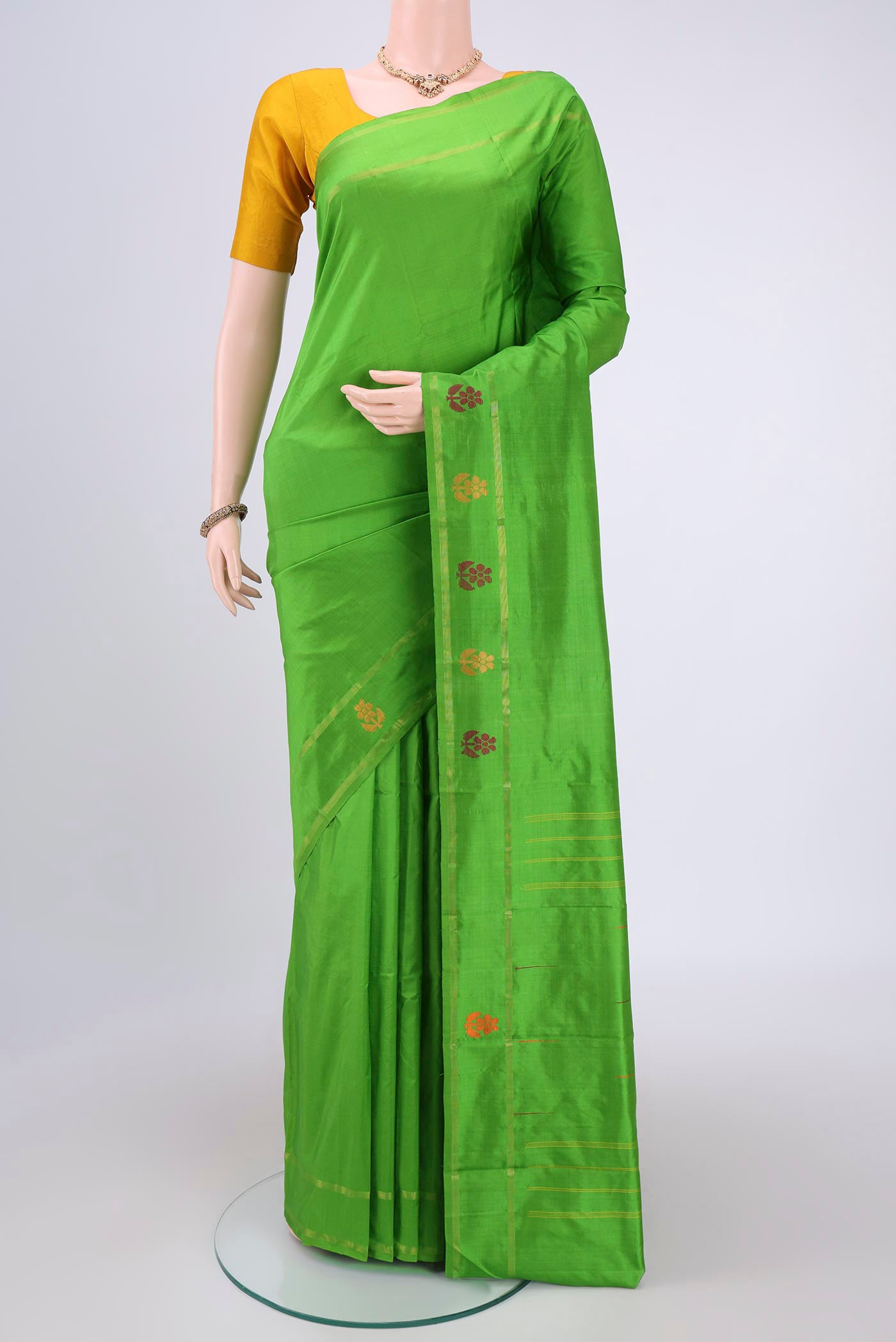 Light Green Dual Tone Kanchipuram Silk Saree with Plain Body and Zari And Thread Border.  displayed on a mannequin