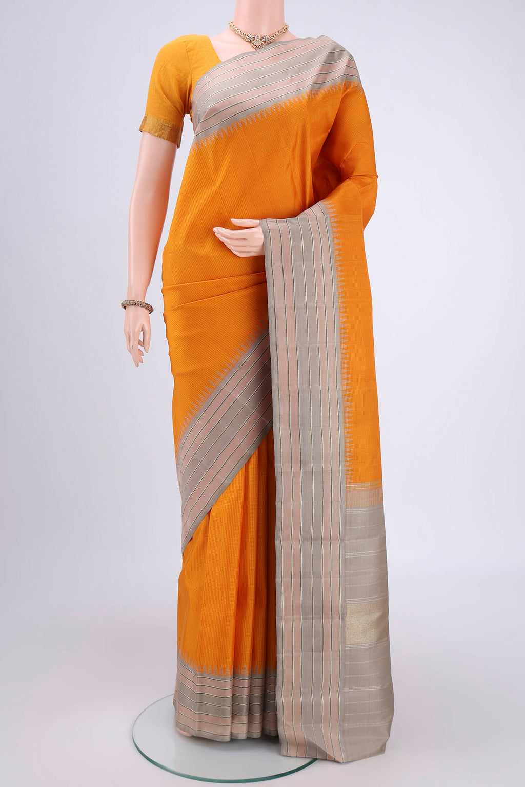 Yellow Kanjivaram Silk Saree with Checked design on the body and Zari Border.  displayed on a mannequin