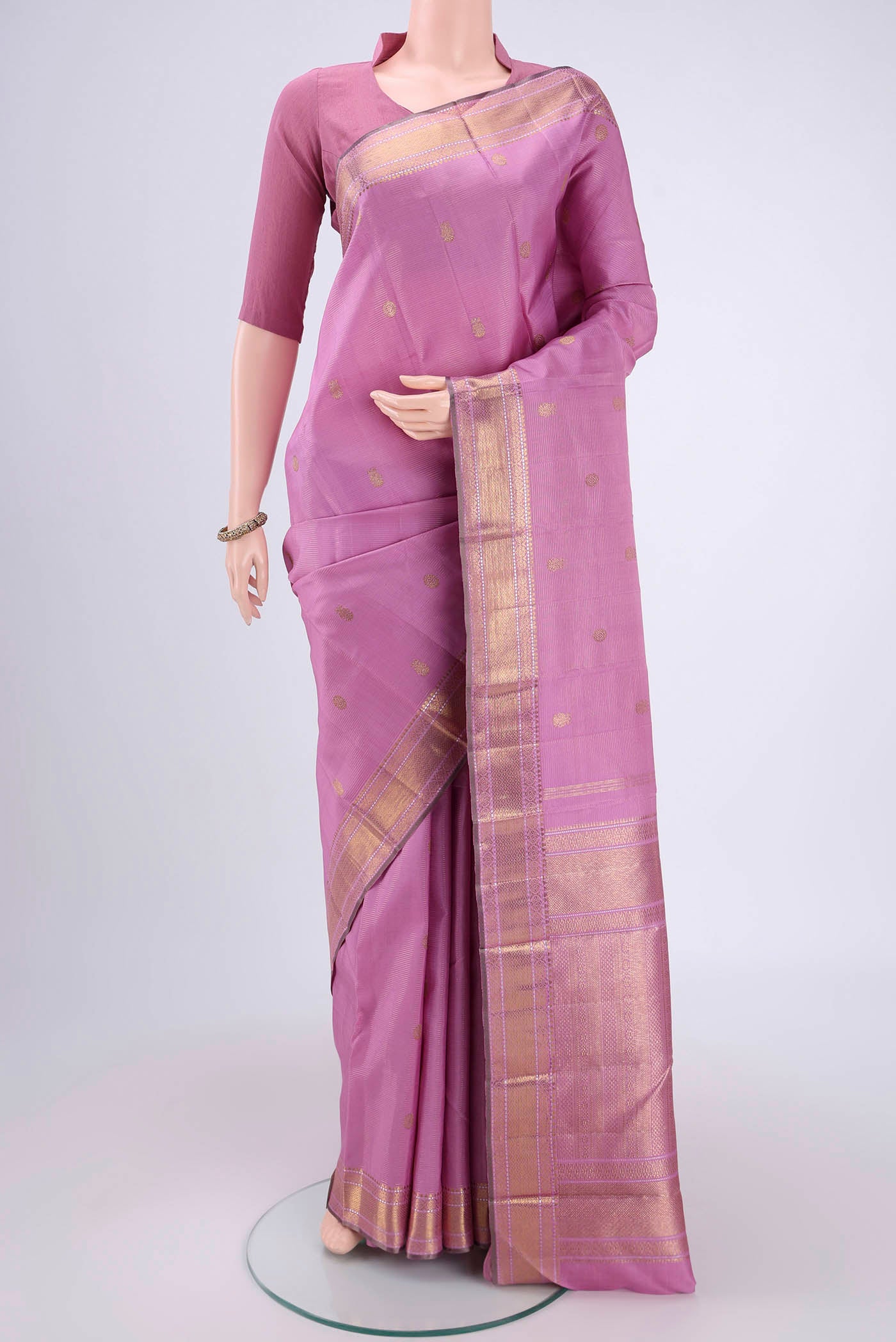 Lilac Kanjivaram Silk Saree with Stripes on the body and Zari Border.  displayed on a mannequin