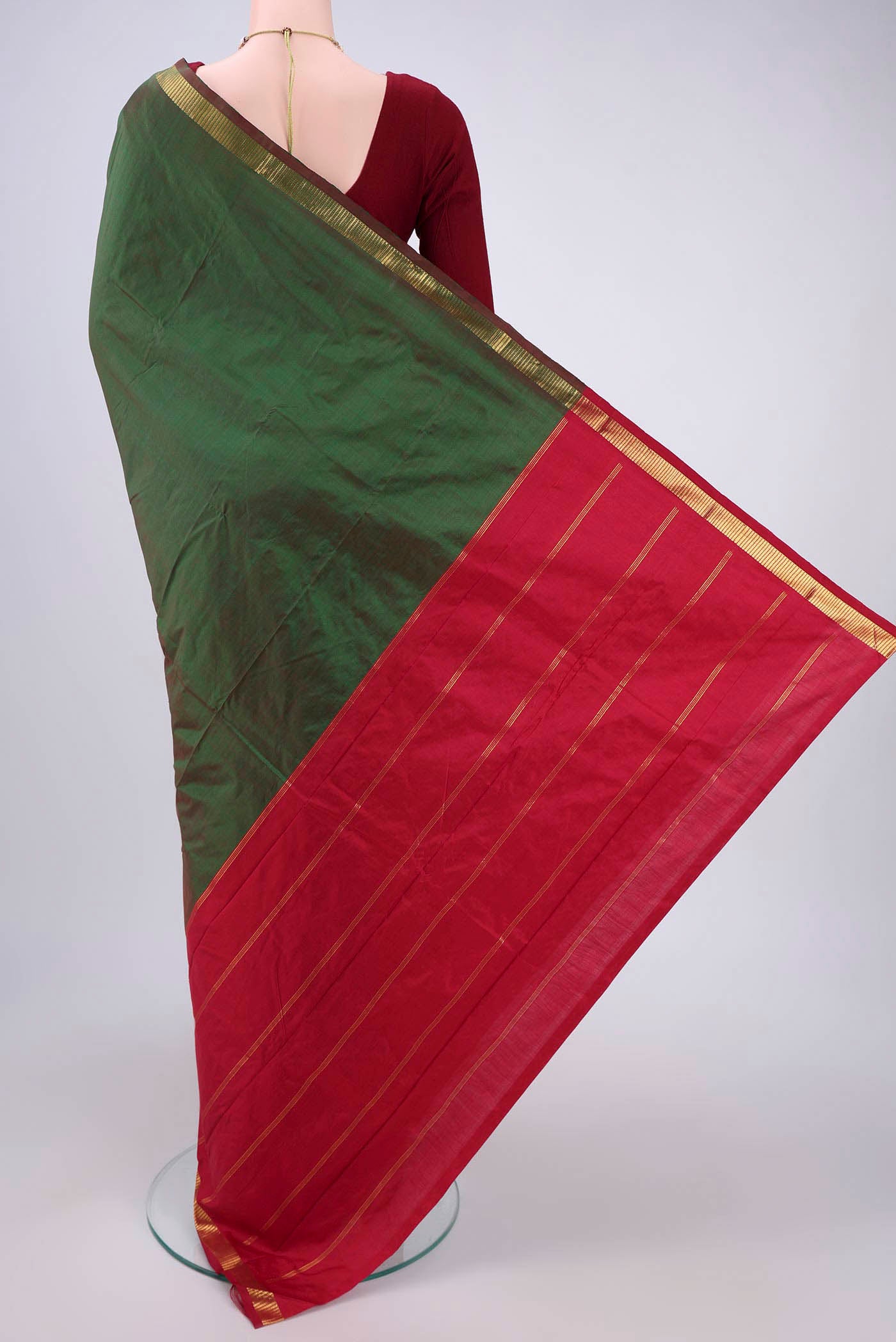 Flat view of Bottle Green Kanchipuram Silk Saree with Plain Body and Zari Border. 