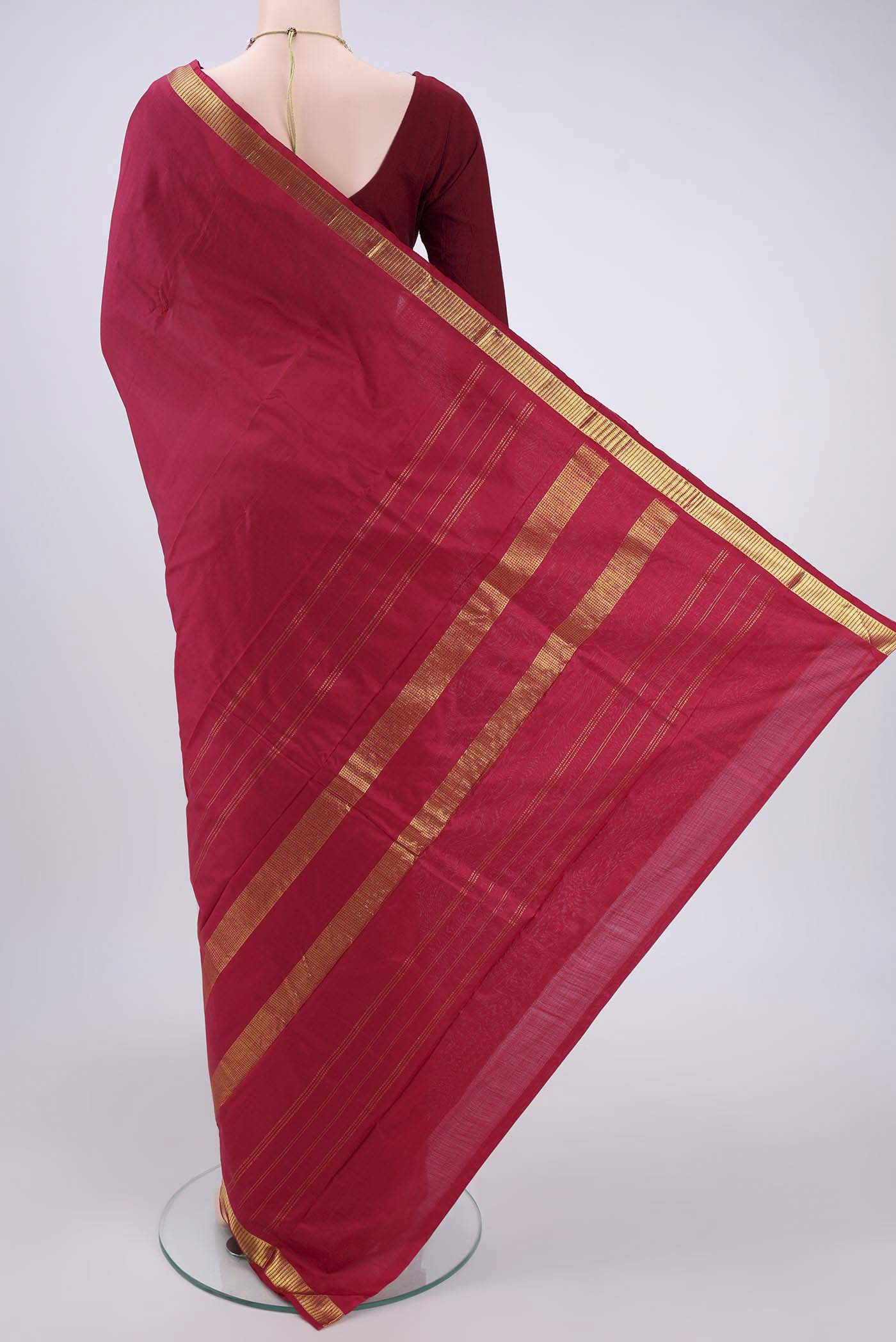 Flat view of Maroon Kanchipuram Silk Saree with Plain Body and Zari Border. 
