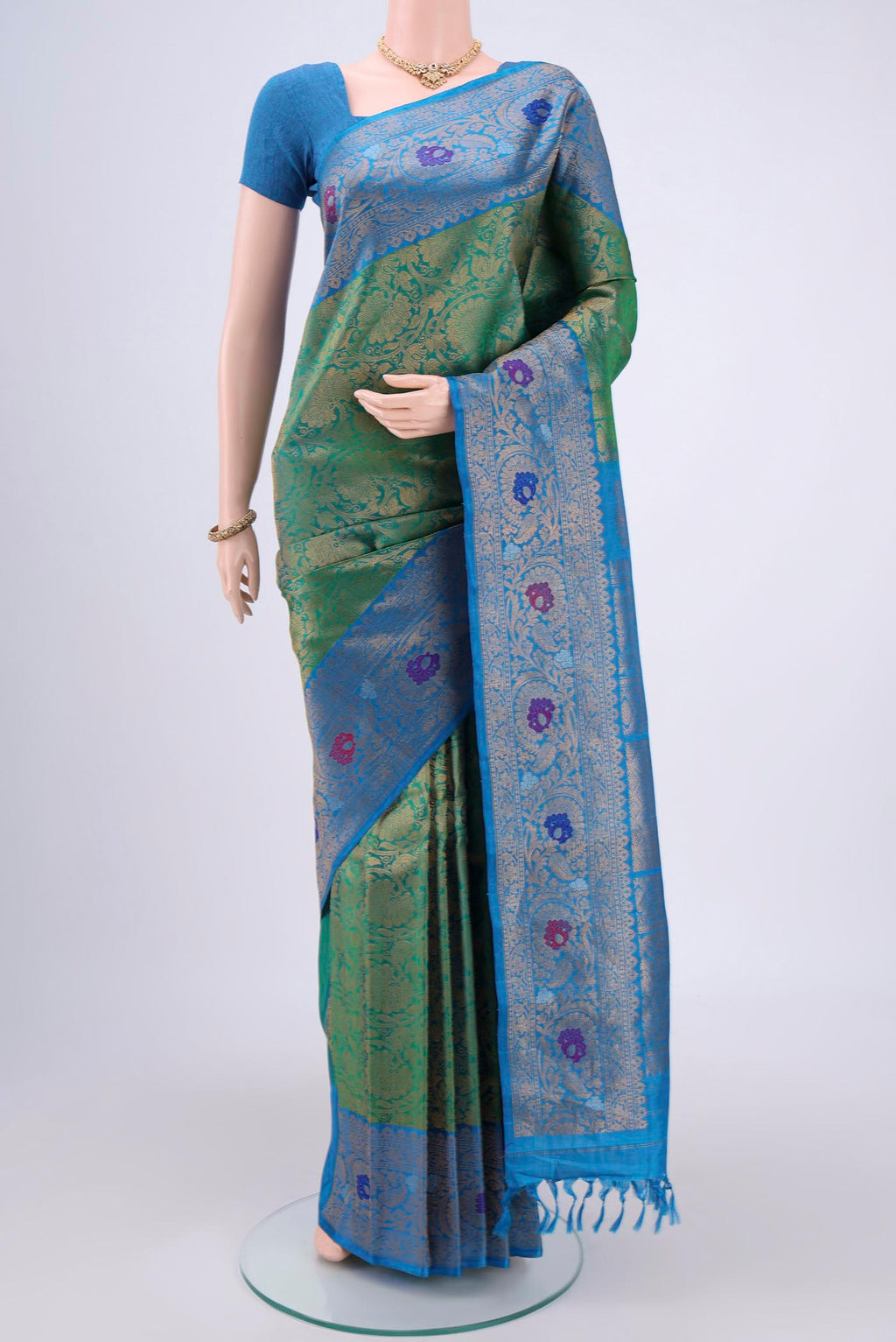 Green Gadwal Silk Saree with Zari Brocade on the body and Zari Border.  displayed on a mannequin