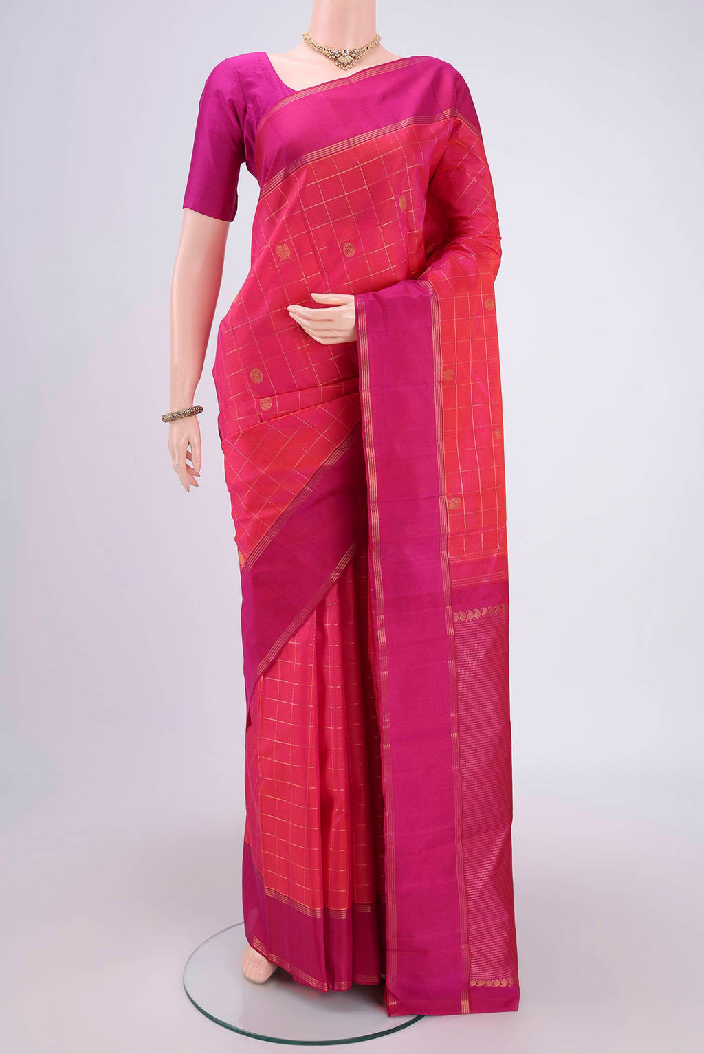 Maroon Dual Tone Kanchipuram Silk Saree with Checked design on the body and Zari Border.  displayed on a mannequin