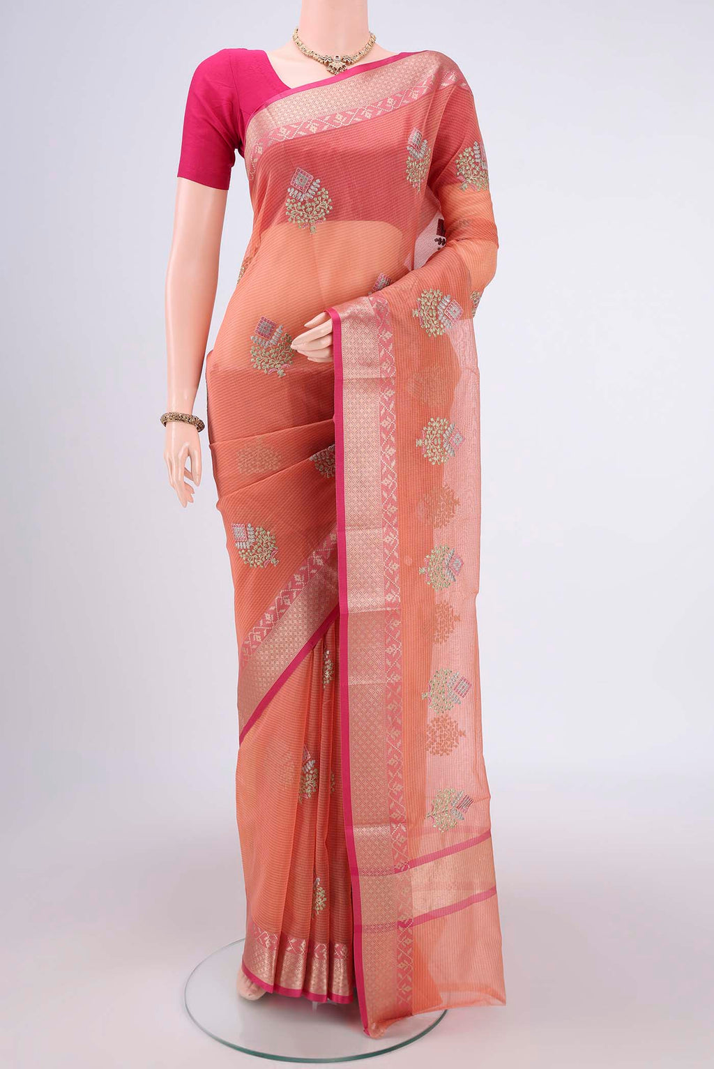 Peach Kota Silk Saree with Embroidery on the body and Plain Border.  displayed on a mannequin