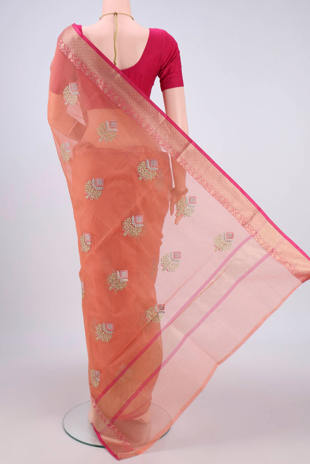 Flat view of Peach Kota Silk Saree with Embroidery on the body and Plain Border. 
