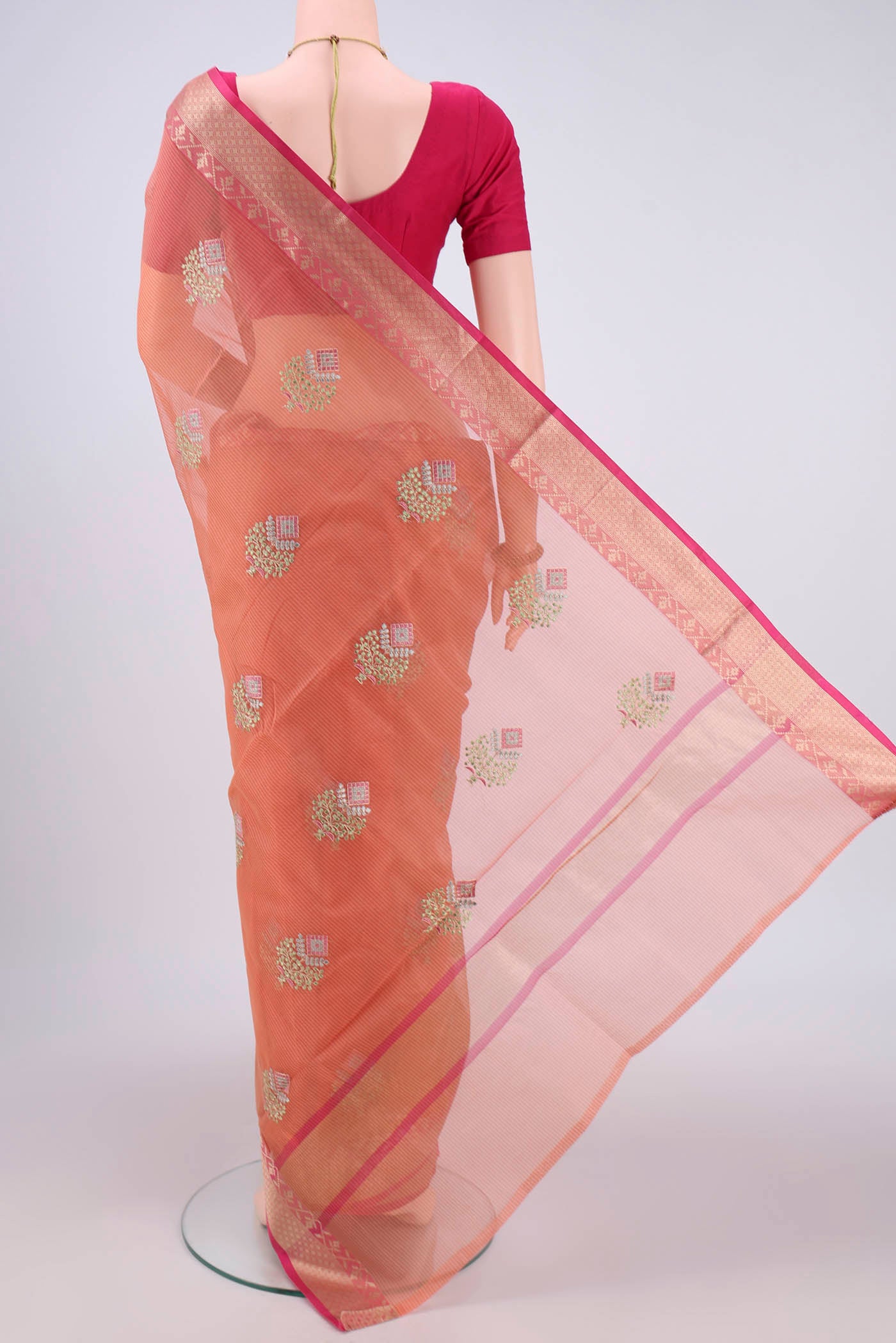 Flat view of Peach Kota Silk Saree with Embroidery on the body and Plain Border. 
