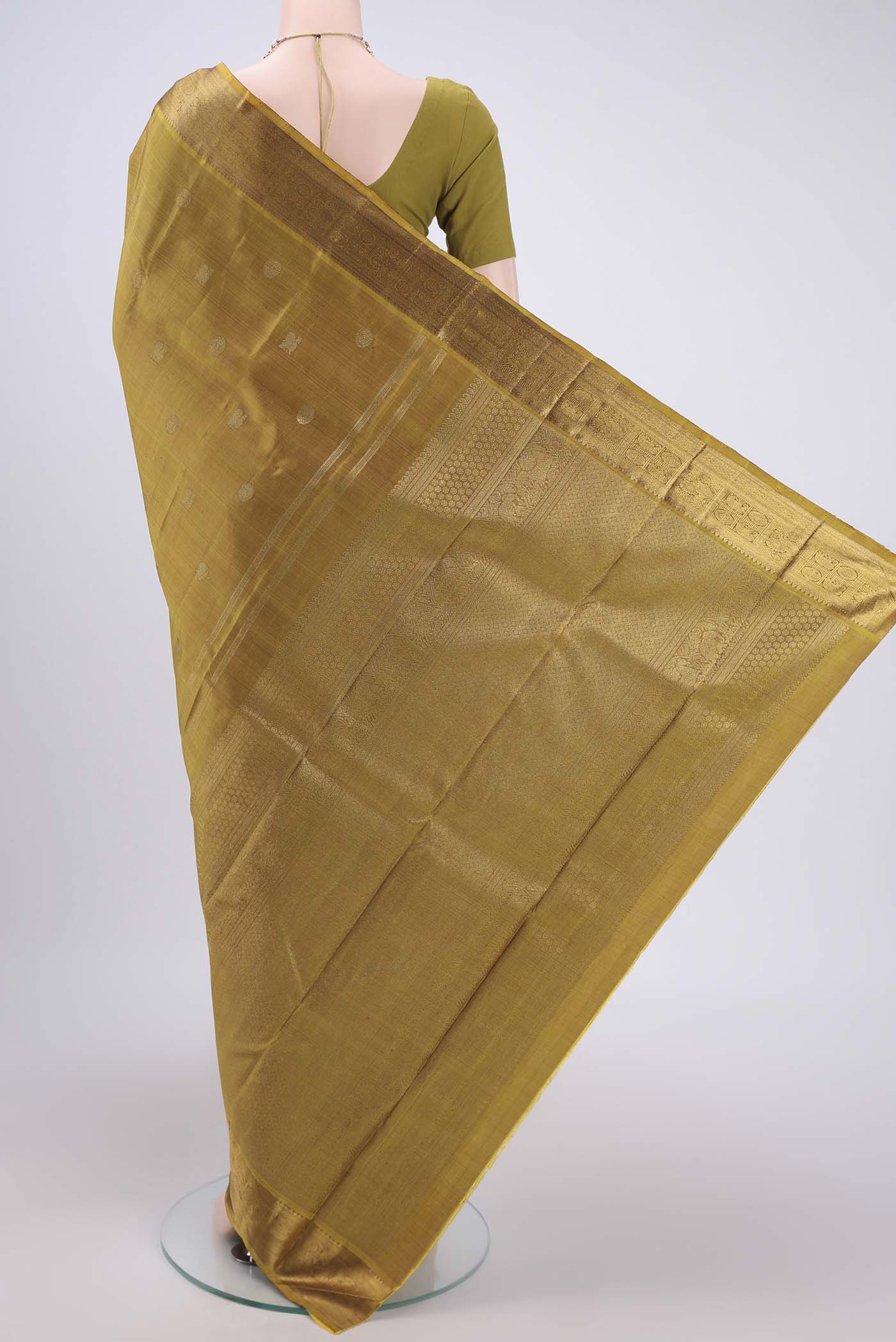 Flat view of Pure Silk Pure Zari Mehandi Green Kanjivaram Saree with Zari Butta on the body and Zari Border. 