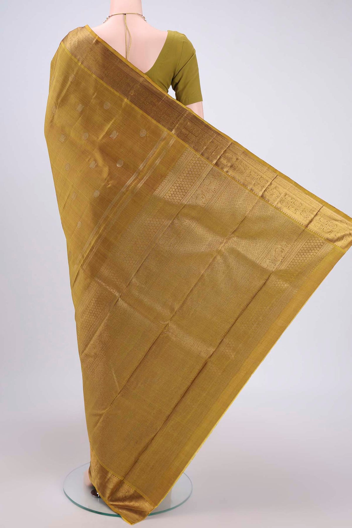 Flat view of Pure Silk Pure Zari Mehandi Green Kanjivaram Saree with Zari Butta on the body and Zari Border. 
