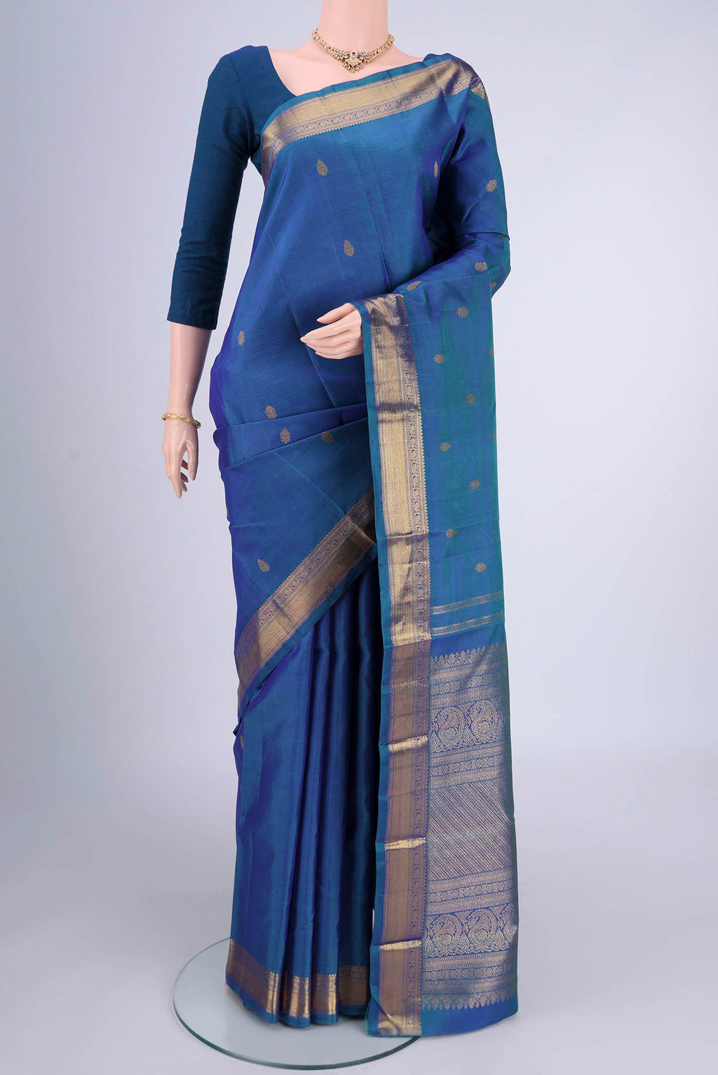Blue Kanchipuram Silk Saree with Zari Butta on the body and Zari Border.  displayed on a mannequin
