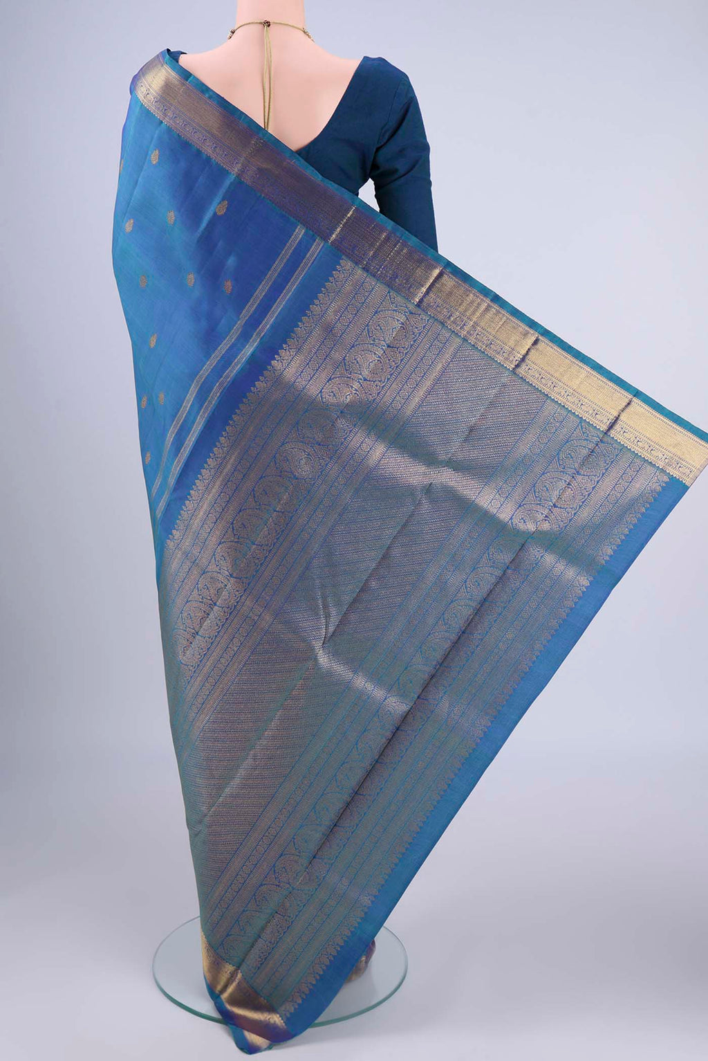 Flat view of Blue Kanchipuram Silk Saree with Zari Butta on the body and Zari Border. 