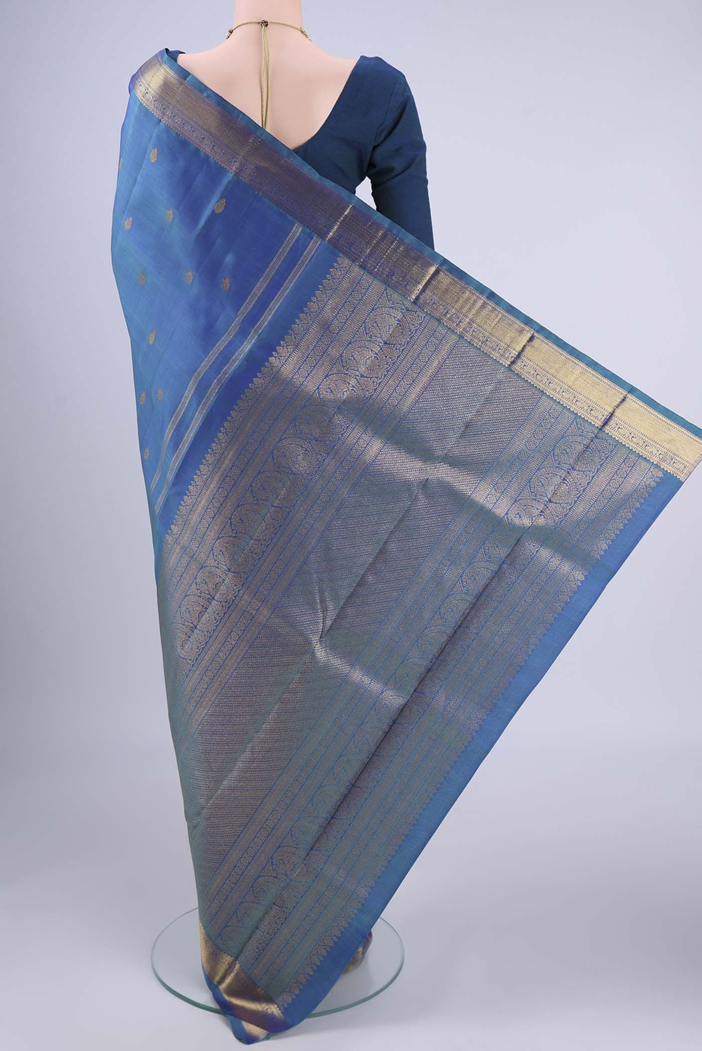 Flat view of Blue Kanchipuram Silk Saree with Zari Butta on the body and Zari Border. 