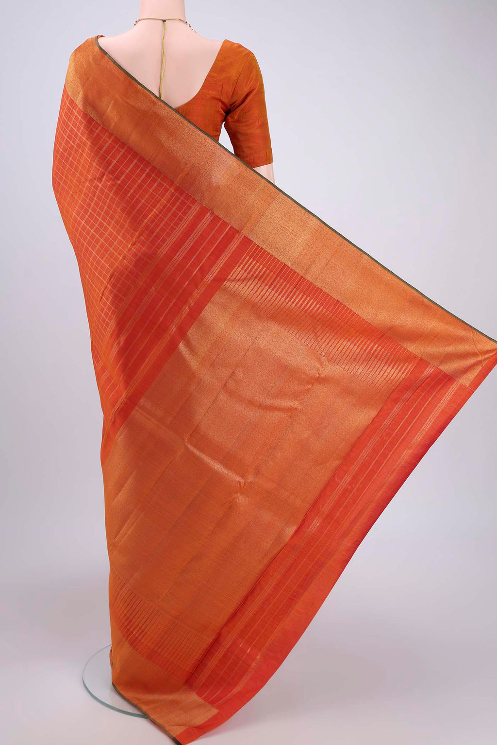 Flat view of Pure Silk Pure Zari Rust Kanjivaram Saree with Checked design on the body and Zari Border. 