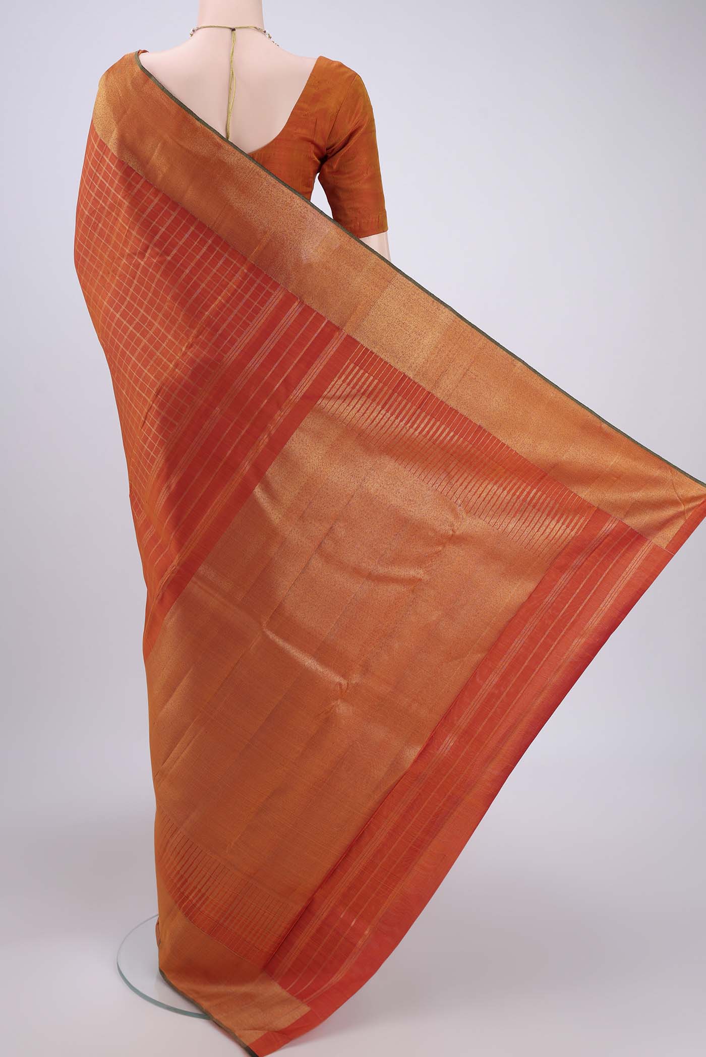 Flat view of Pure Silk Pure Zari Rust Kanjivaram Saree with Checked design on the body and Zari Border. 