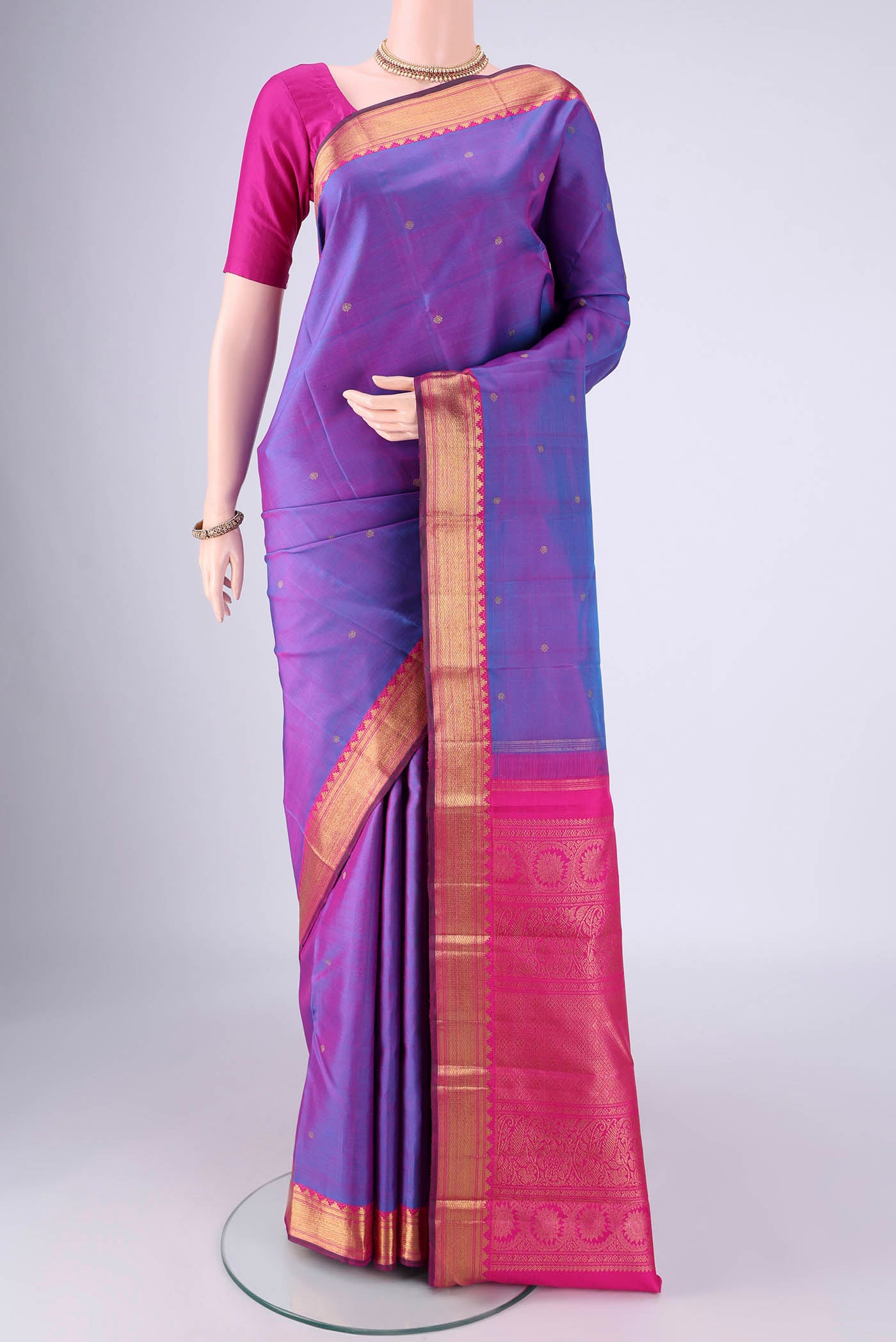 Pure Silk Pure Zari Purple Kanjivaram Saree with Zari Butta on the body and Zari Border.  displayed on a mannequin