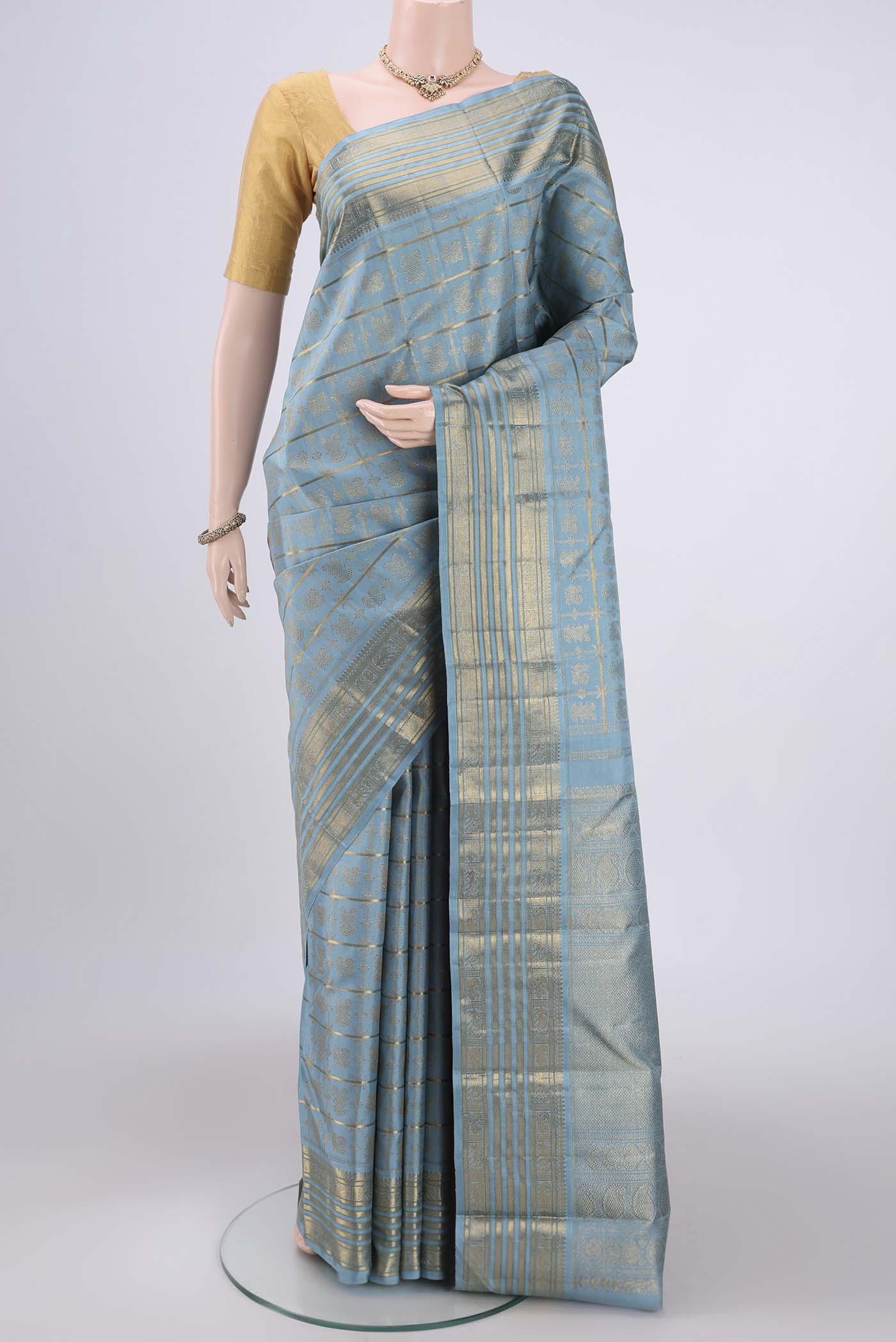 Pure Silk Pure Zari Light Blue Kanchipuram Saree with Zari Brocade on the body and Zari Border.  displayed on a mannequin