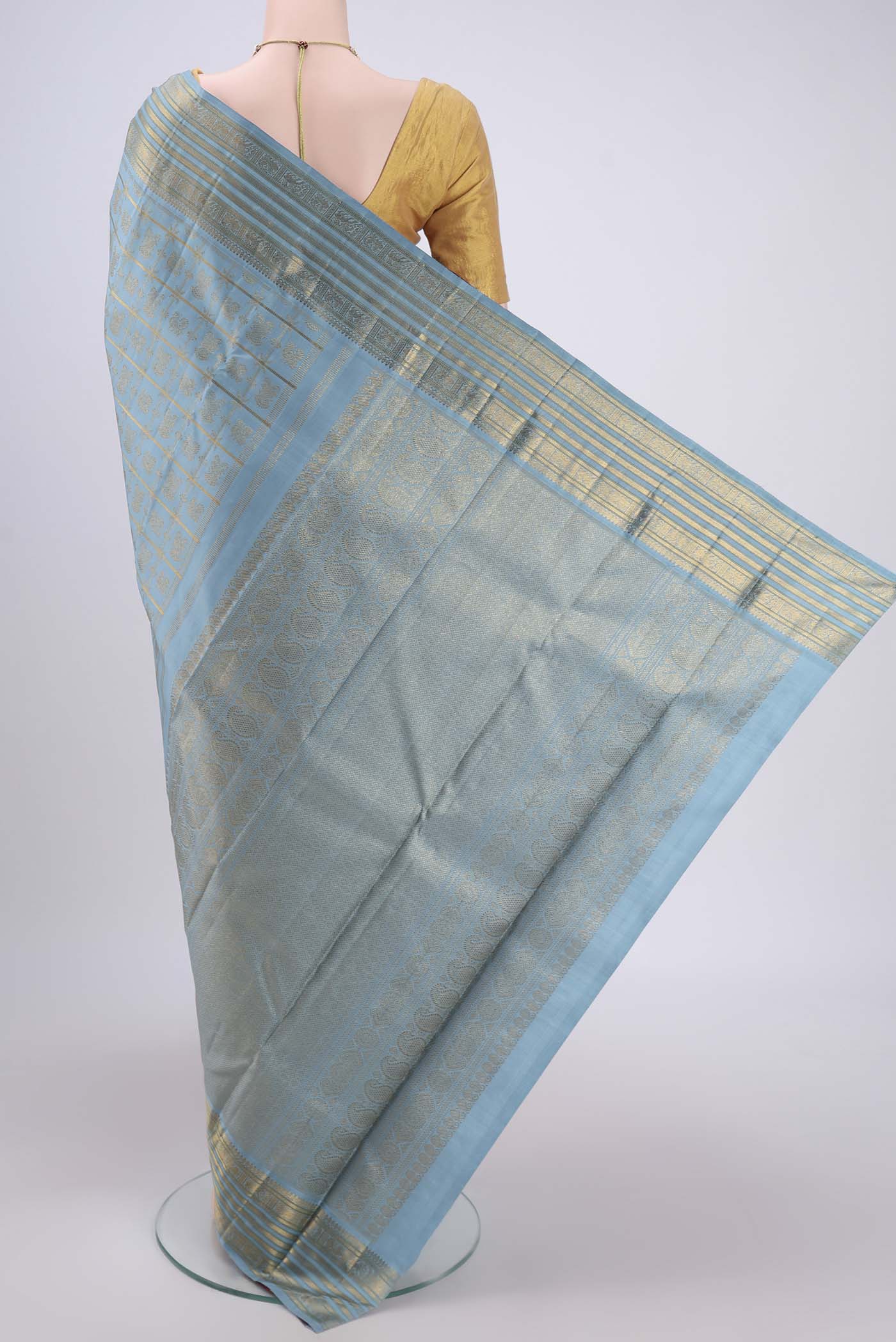 Flat view of Pure Silk Pure Zari Light Blue Kanchipuram Saree with Zari Brocade on the body and Zari Border. 