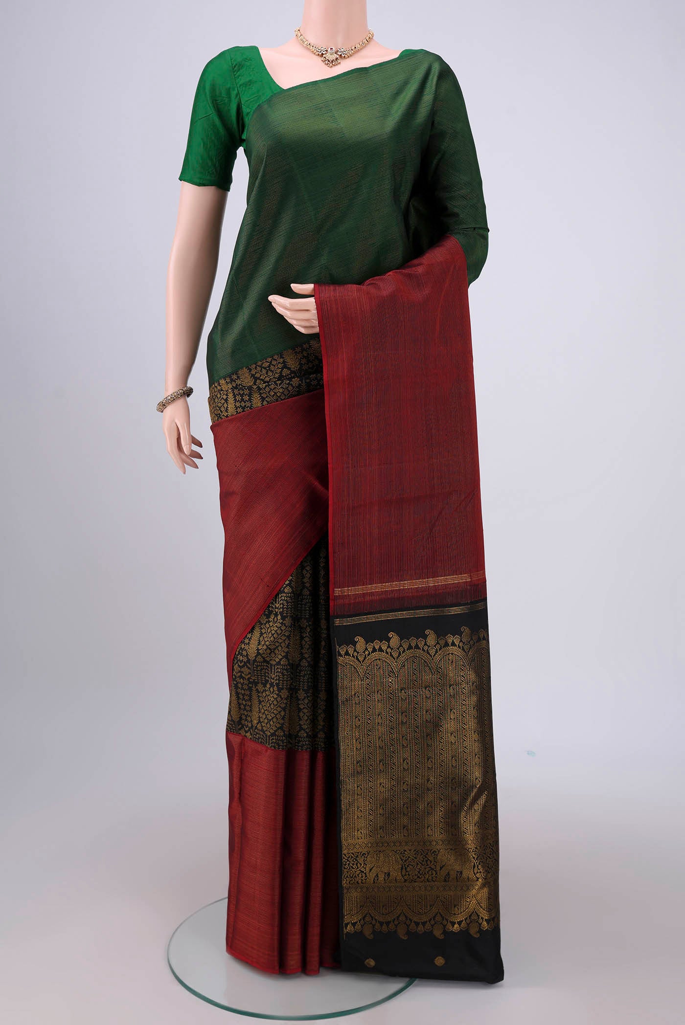 Black Dual Tone Kanchipuram Silk Saree with Zari Butta on the body and Ganga Jamuna Border.  displayed on a mannequin