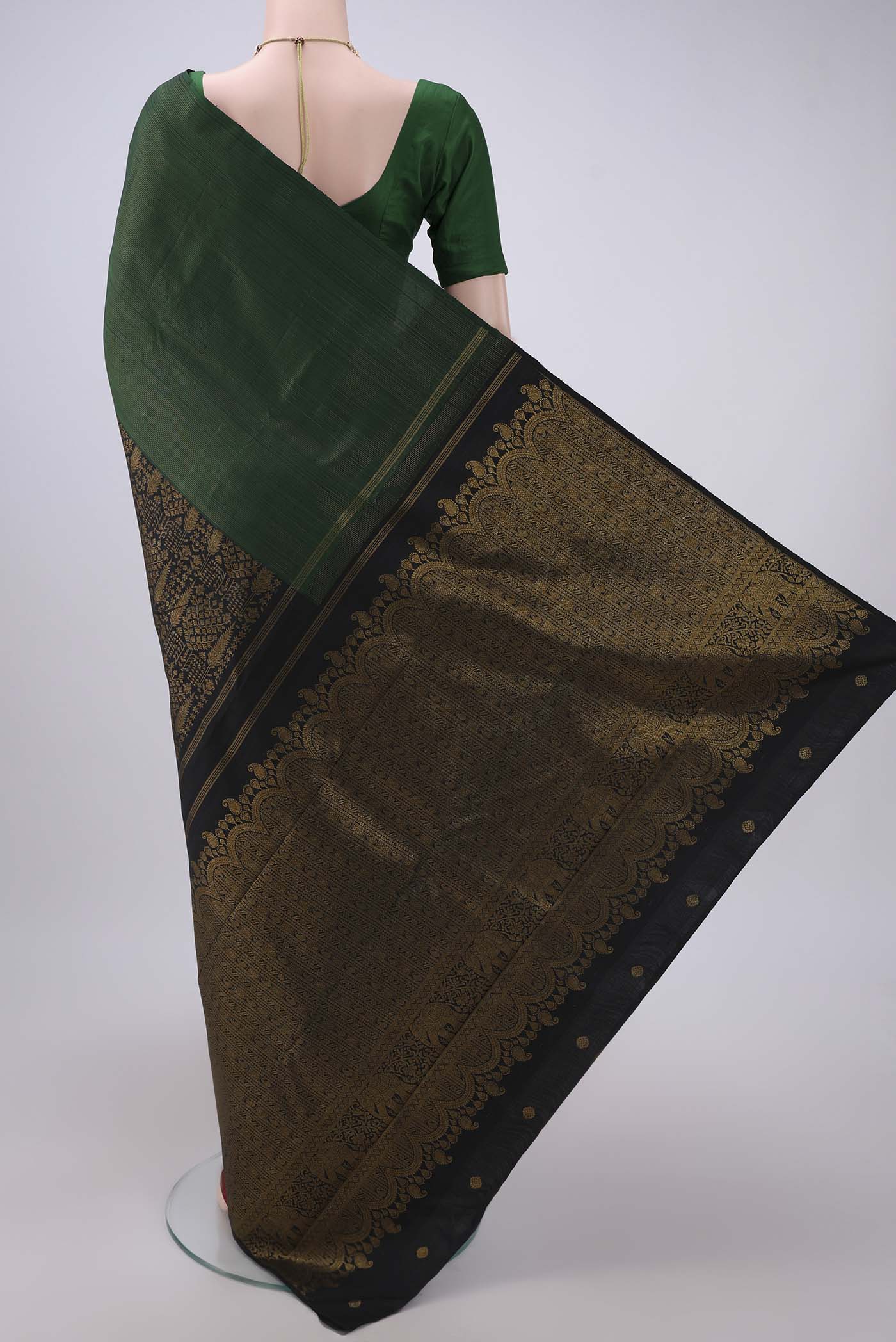 Flat view of Black Dual Tone Kanchipuram Silk Saree with Zari Butta on the body and Ganga Jamuna Border. 