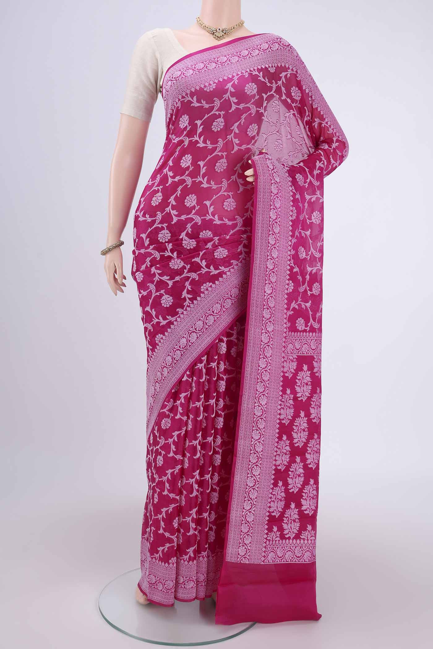 Rani Pink Blended Banarasi Georgette Saree with Thread Brocade on the body and Zari Border.  displayed on a mannequin