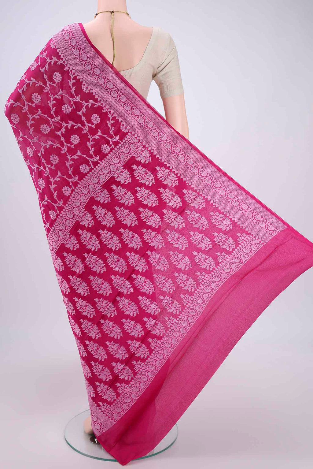 Flat view of Rani Pink Blended Banarasi Georgette Saree with Thread Brocade on the body and Zari Border. 