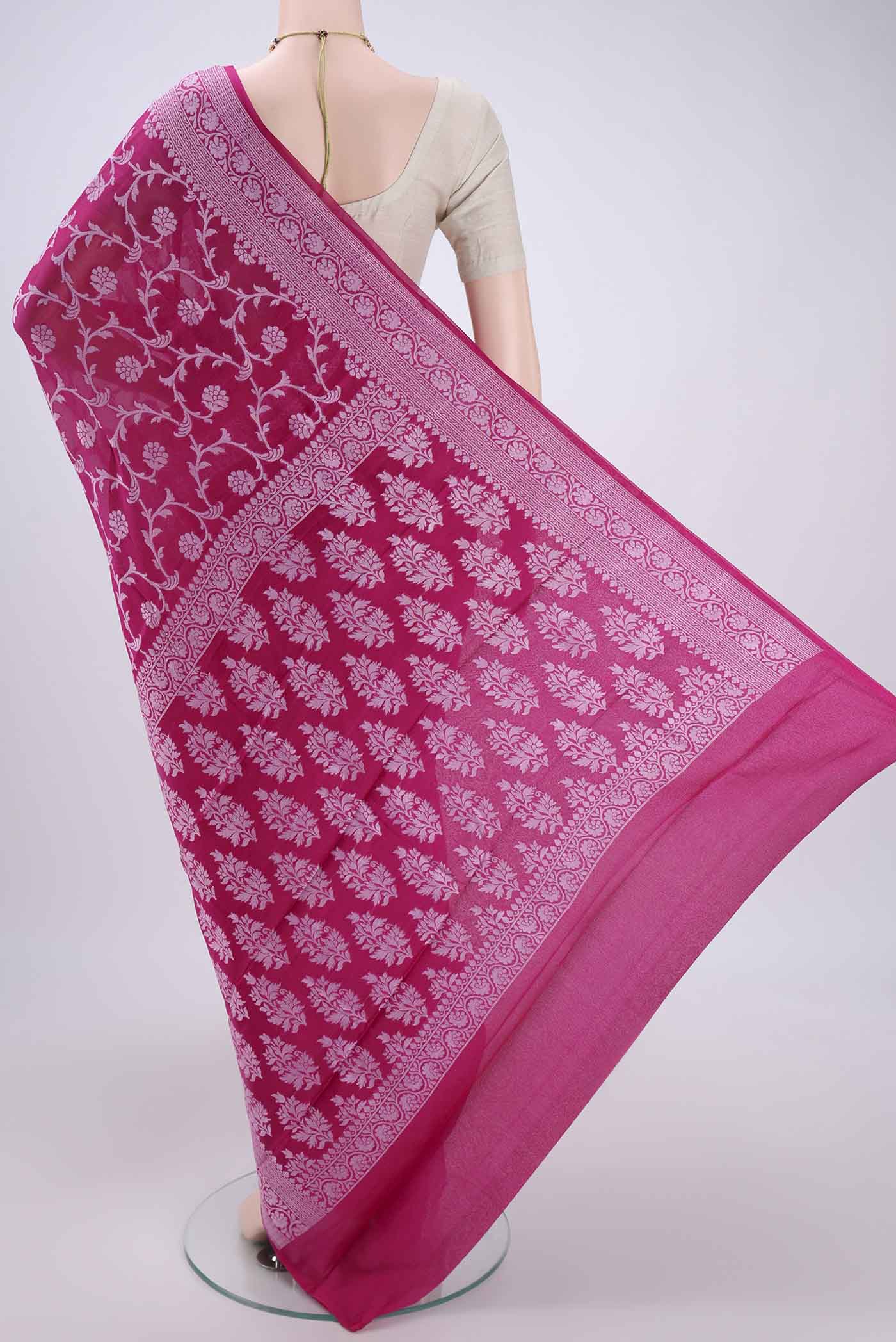 Flat view of Rani Pink Blended Banarasi Georgette Saree with Thread Brocade on the body and Zari Border. 