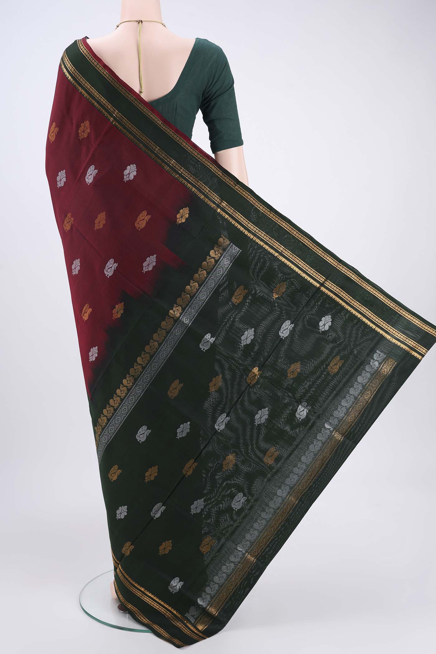Flat view of Maroon Uppada Silk Saree with Zari Butta on the body and Zari Border. 
