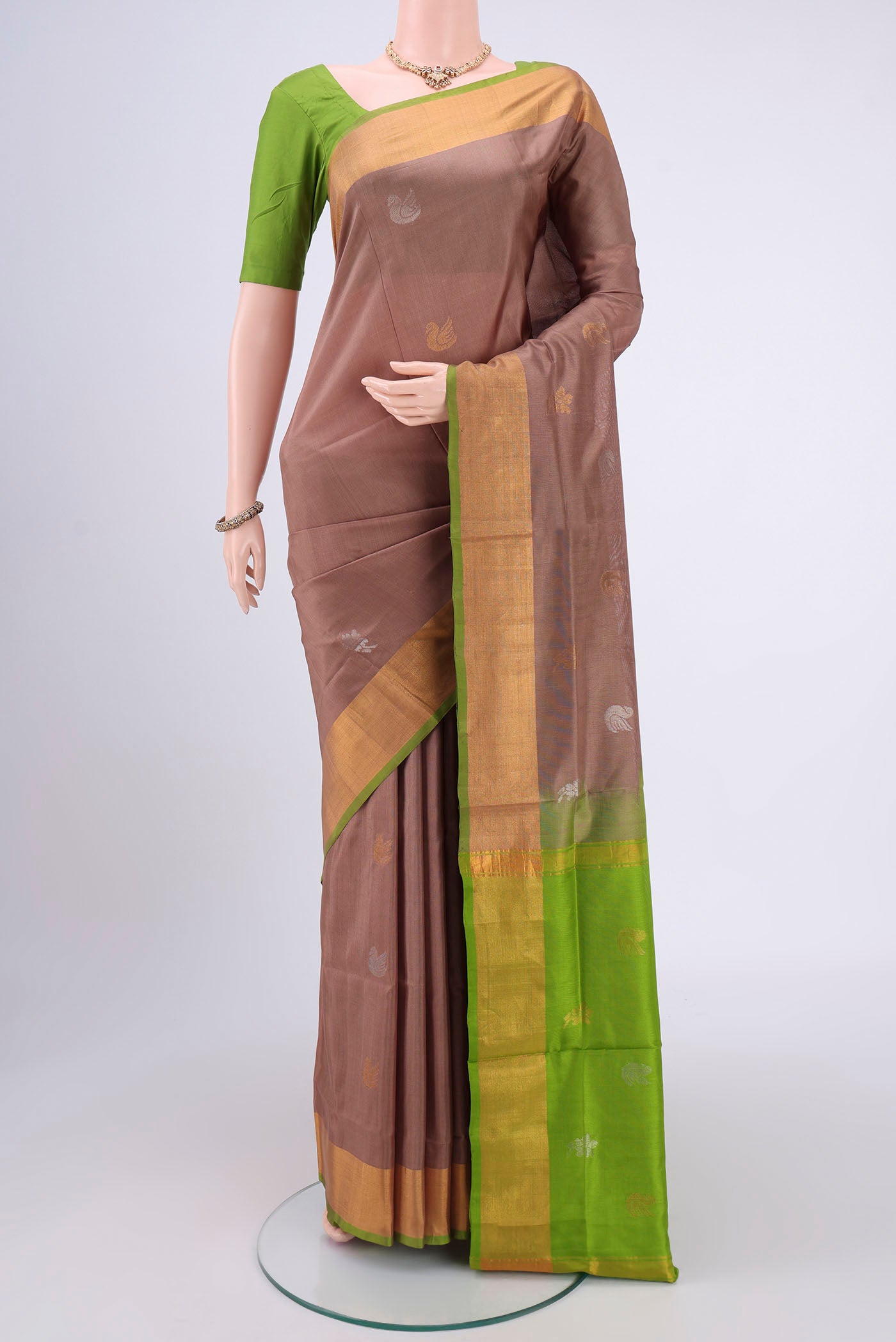 Brown Uppada Silk Saree with Zari Butta on the body and Zari Border.  displayed on a mannequin
