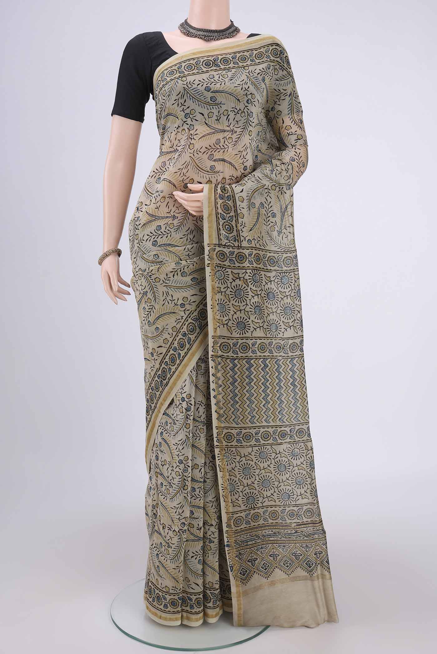 Beige Chanderi Silk Cotton Saree with Ajrakh Print on the body and Zari Border.  displayed on a mannequin