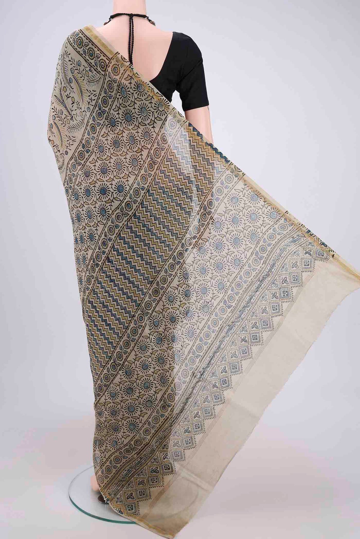 Flat view of Beige Chanderi Silk Cotton Saree with Ajrakh Print on the body and Zari Border. 