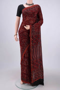 Maroon Chanderi Silk Cotton Saree with Ajrakh Print on the body and Zari Border.  displayed on a mannequin