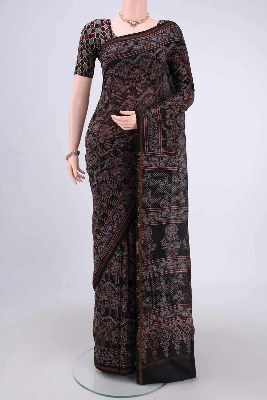 Black Chanderi Silk Cotton Saree with Ajrakh Print on the body and Zari Border.  displayed on a mannequin