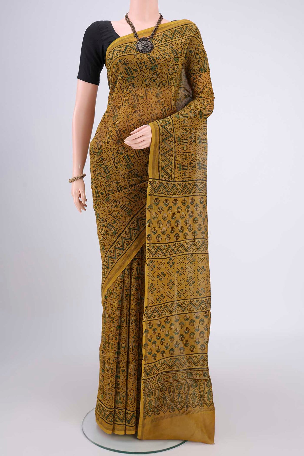 Yellow Chanderi Silk Cotton Saree with Ajrakh Print on the body and Zari Border.  displayed on a mannequin