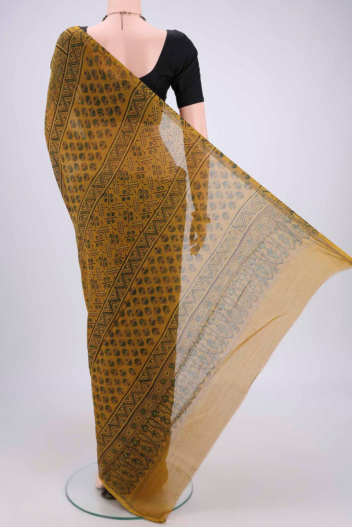 Flat view of Yellow Chanderi Silk Cotton Saree with Ajrakh Print on the body and Zari Border. 