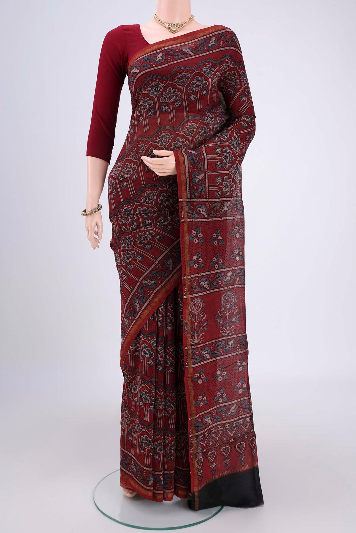 Maroon Chanderi Silk Cotton Saree with Ajrakh Print on the body and Zari Border.  displayed on a mannequin