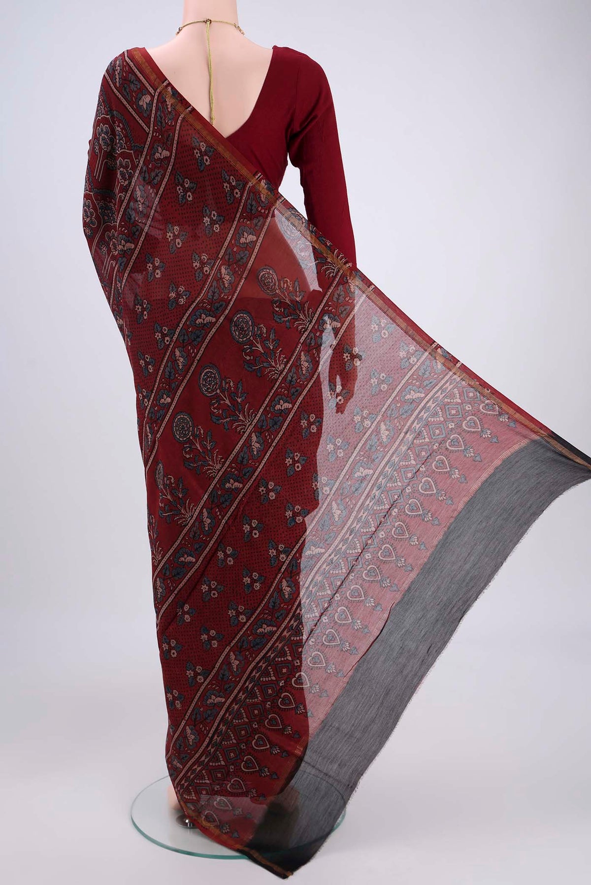 Flat view of Maroon Chanderi Silk Cotton Saree with Ajrakh Print on the body and Zari Border. 