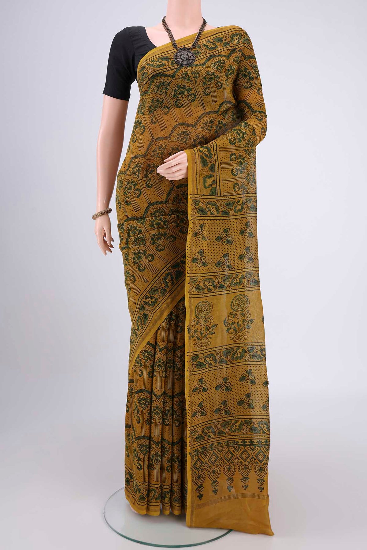 Yellow Chanderi Silk Cotton Saree with Ajrakh Print on the body and Zari Border.  displayed on a mannequin