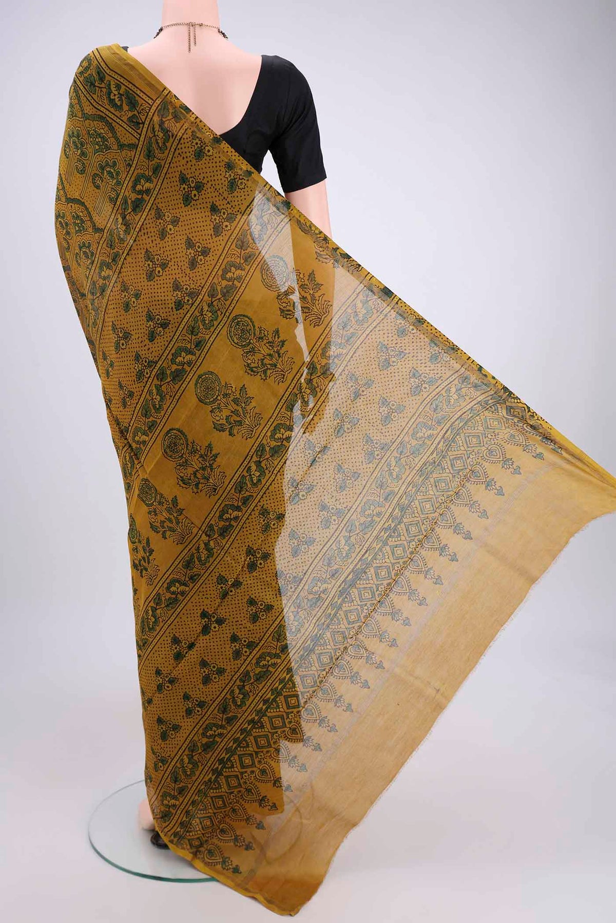 Flat view of Yellow Chanderi Silk Cotton Saree with Ajrakh Print on the body and Zari Border. 