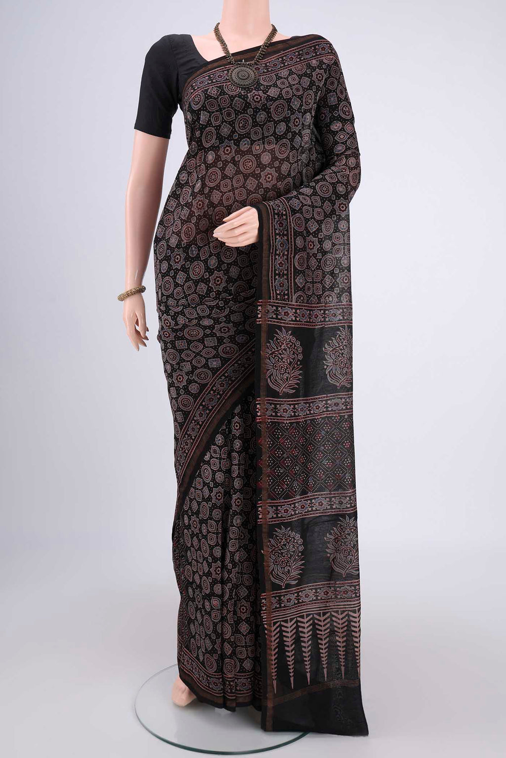 Black Chanderi Silk Cotton Saree with Ajrakh Print on the body and Zari Border.  displayed on a mannequin