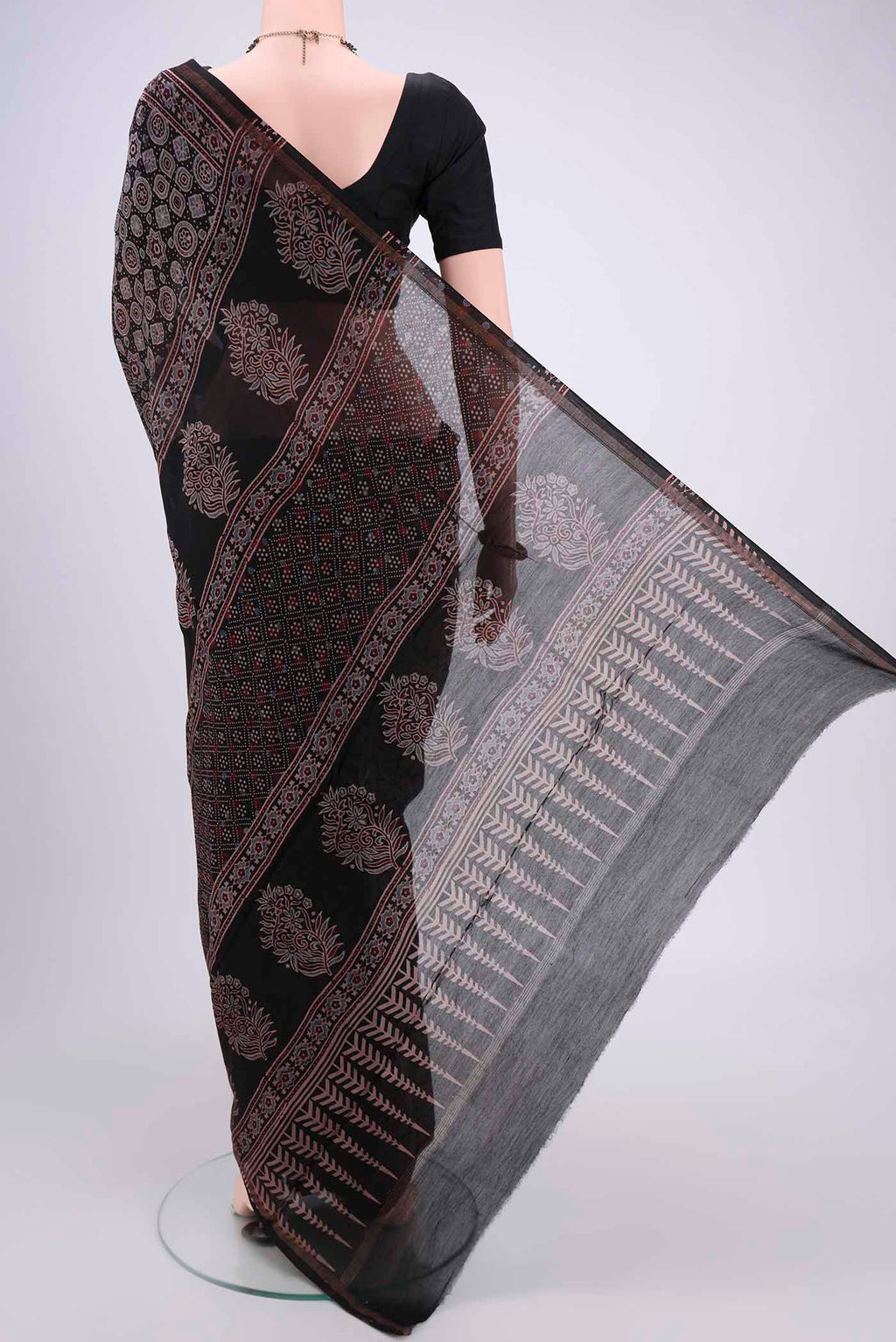 Flat view of Black Chanderi Silk Cotton Saree with Ajrakh Print on the body and Zari Border. 