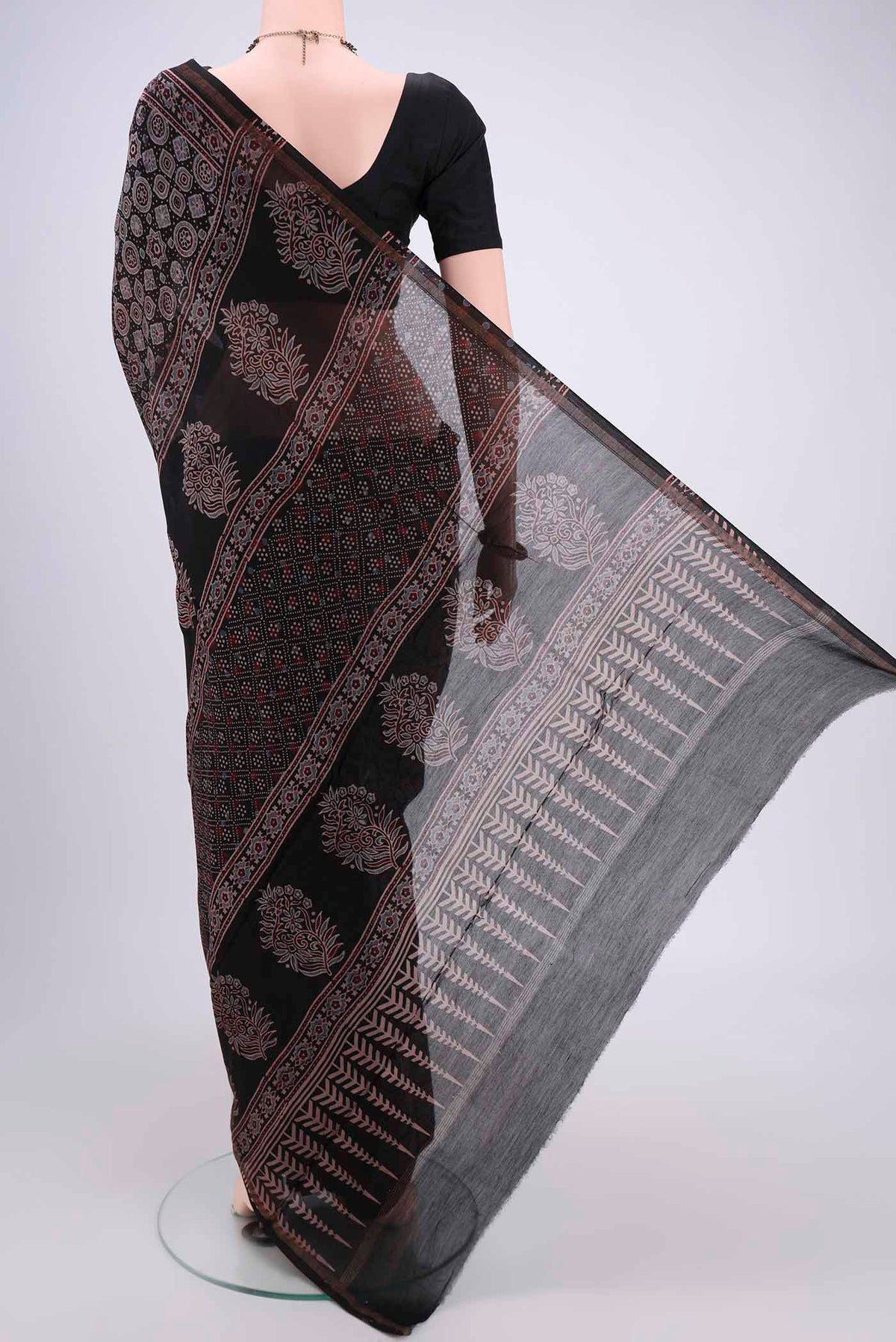 Flat view of Black Chanderi Silk Cotton Saree with Ajrakh Print on the body and Zari Border. 