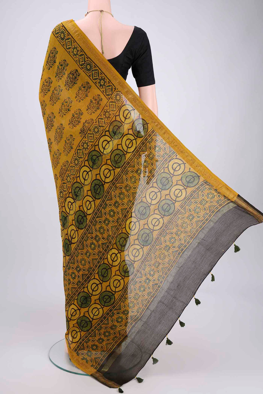 Flat view of Mustard Chanderi Silk Cotton Saree with Ajrakh Print on the body and Zari Border. 