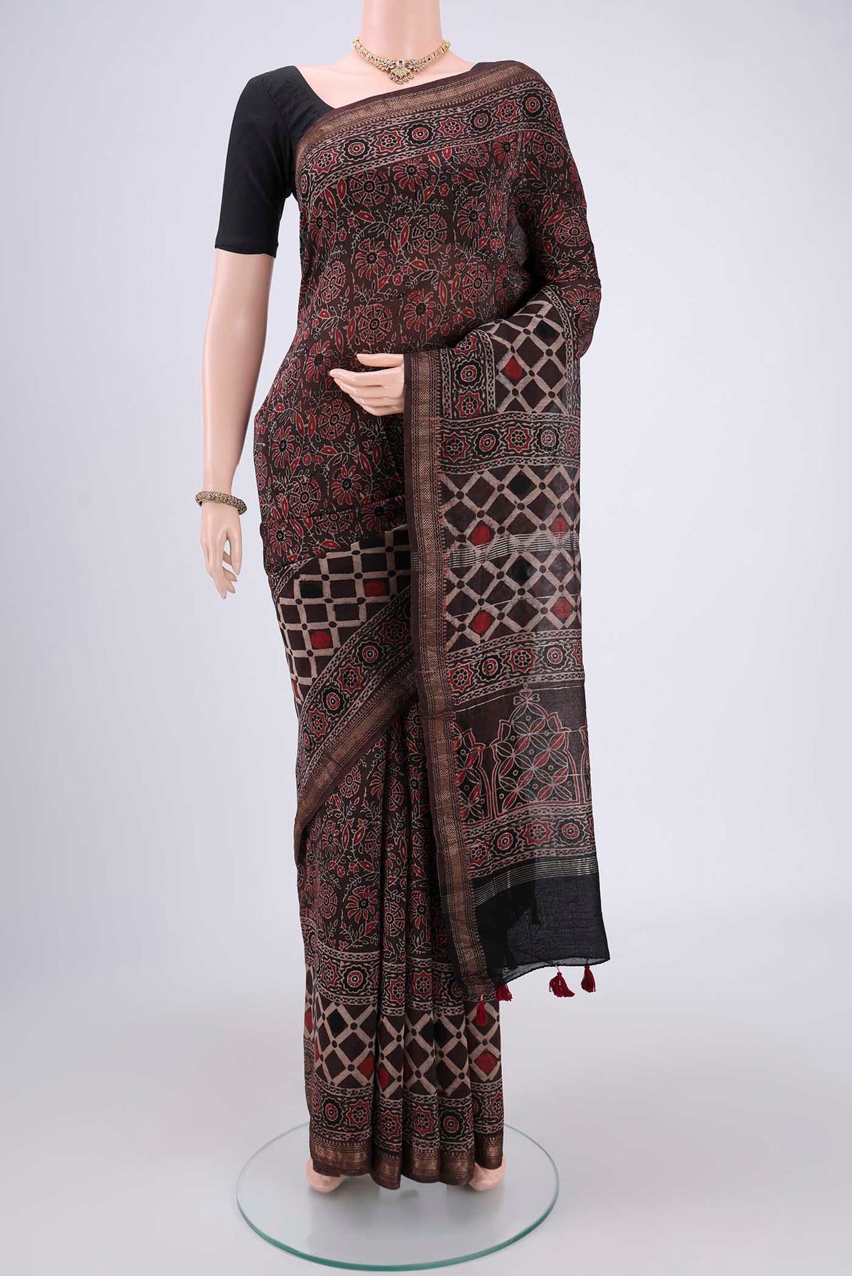 Black Chanderi Silk Cotton Saree with Ajrakh Print on the body and Zari Border.  displayed on a mannequin