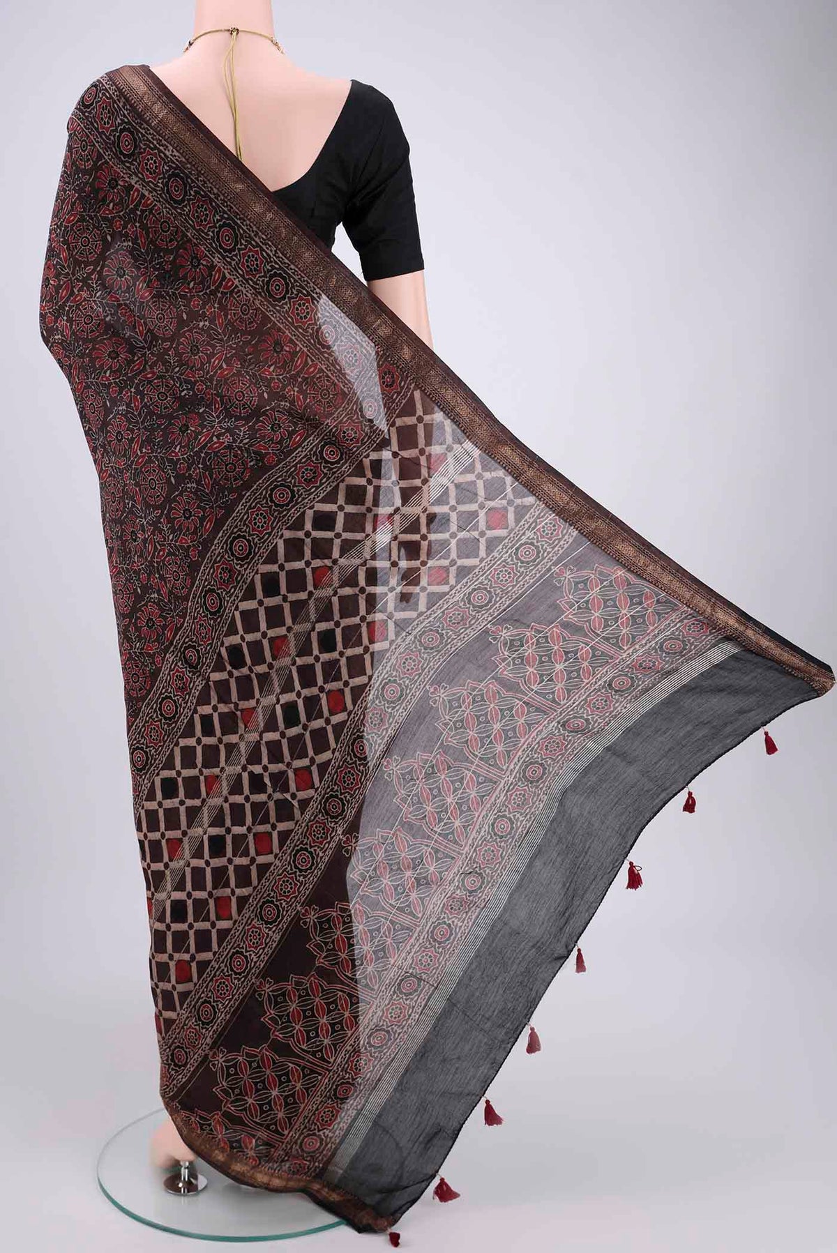Flat view of Black Chanderi Silk Cotton Saree with Ajrakh Print on the body and Zari Border. 