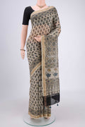 Beige Chanderi Silk Cotton Saree with Ajrakh Print on the body and Zari Border.  displayed on a mannequin