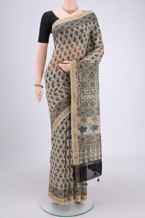 Beige Chanderi Silk Cotton Saree with Ajrakh Print on the body and Zari Border.  displayed on a mannequin